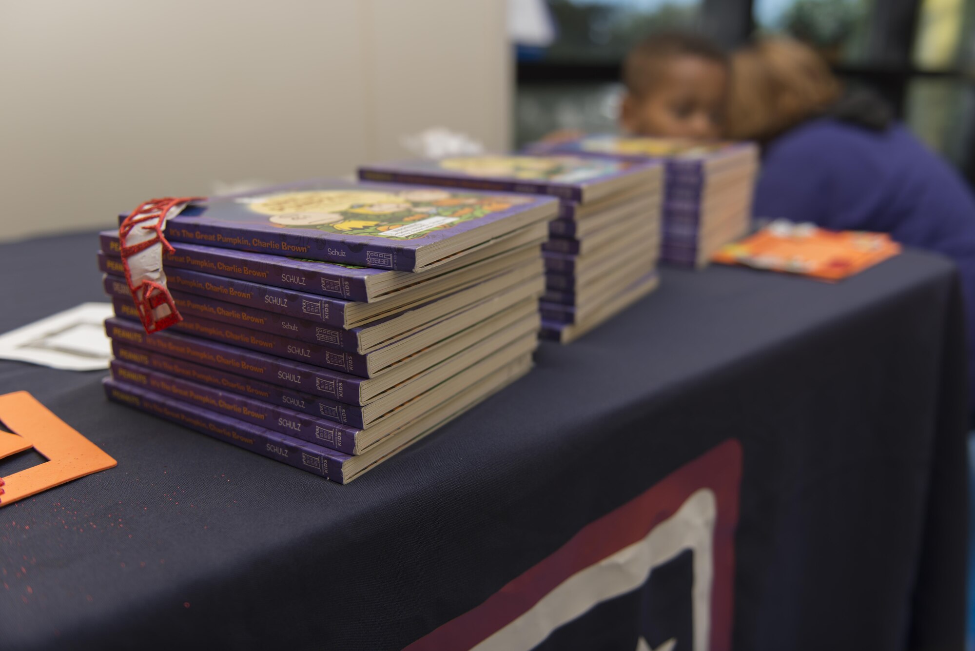 Copies of “It’s the Great Pumpkin, Charlie Brown” sit on display at the Child Development Center Oct. 12, 2016 on Keesler Air Force Base, Miss. To commemorate the book’s 50th anniversary, members of the USO read the story to children at the CDC. (U.S. Air Force photo by Andre’ Askew/Released) 