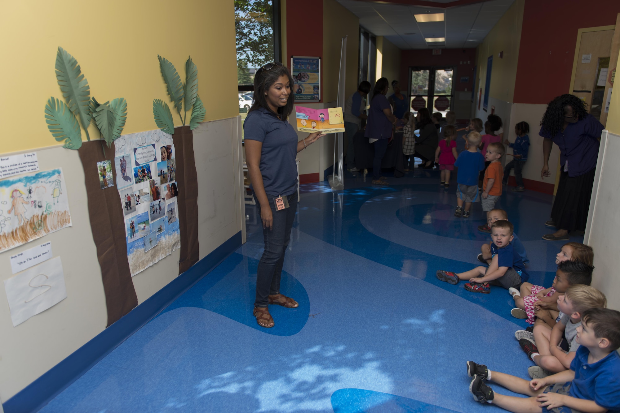 Nicole Lewis, USO Programs Manager,  reads “It’s the Great Pumpkin, Charlie Brown” to children in the Child Development Center Oct 12, 2016 on Keesler Air Force Base, Miss. The USO-led event was held to commemorate the book’s 50th anniversary.  (U.S. Air Force photo by Andre’ Askew/Released)