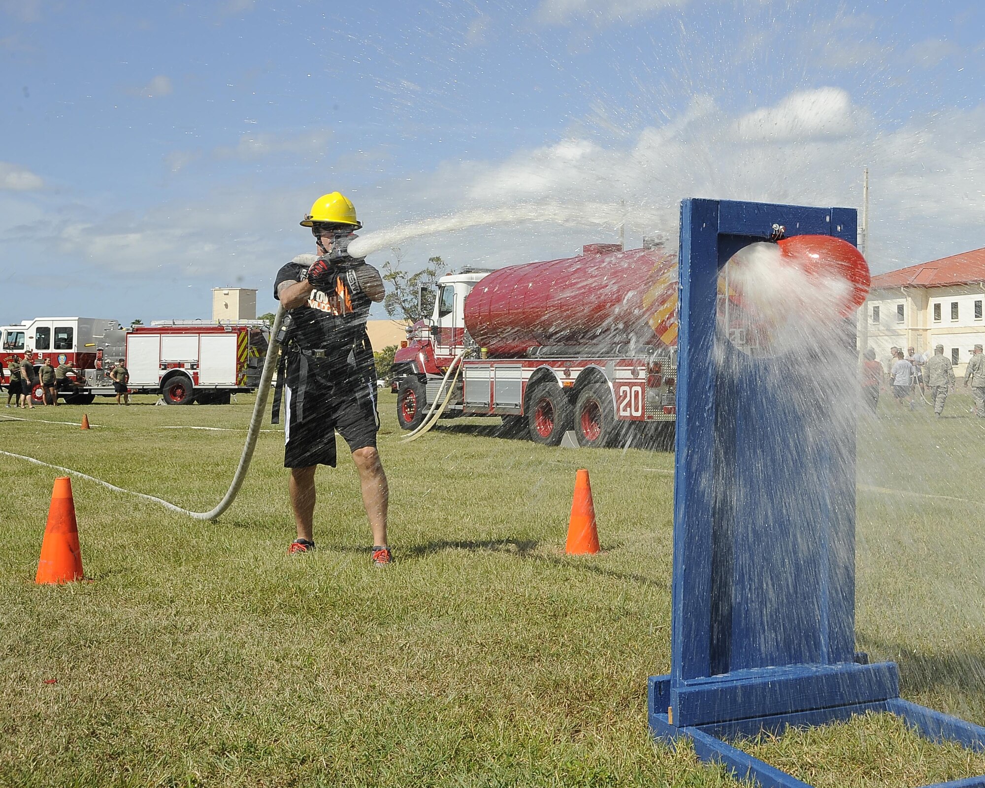 A participant sprays a target during the MacDill’s Inaugural Firefighter’s Challenge at MacDill Air Force Base, Fla., Oct. 14, 2016. During the event, teams of four participated and performed both individual and group tasks in order to complete the challenge. (U.S. Air Force photo by Airman 1st Class Mariette Adams)