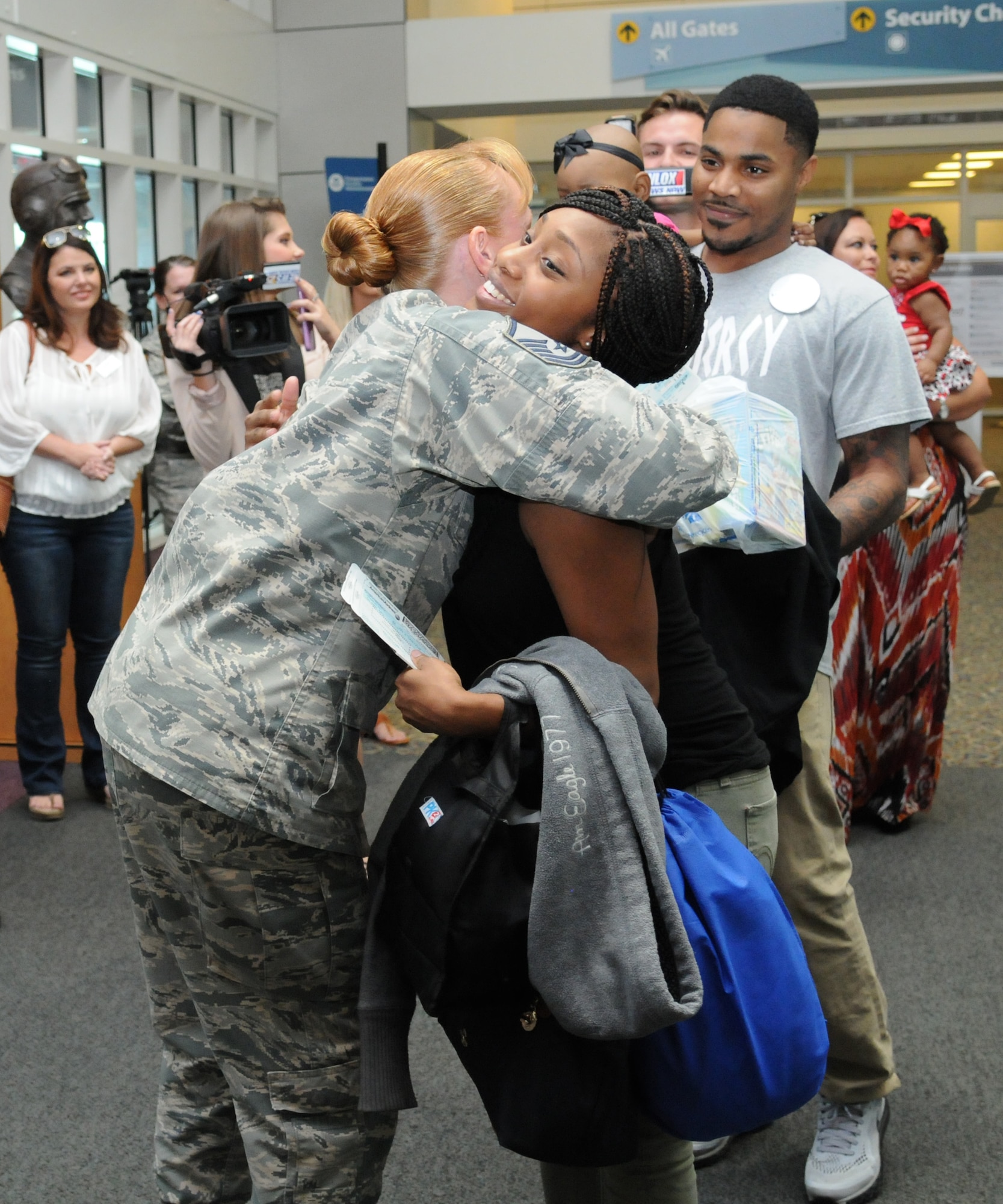 Master Sgt. Krista Mercadel, 81st Force Support Squadron military personnel section superintendent, hugs Staff Sgt. Devanie Rainey, 81st FSS customer support supervisor, upon her arrival to the Gulfport-Biloxi International Airport Oct. 14, 2016, Gulfport, Miss. The Make-A-Wish Foundation flew the Rainey family to Disney World after their daughter, Saniya, was diagnosed with germ cell tumors. (U.S. Air Force photo by Kemberly Groue/Released)
