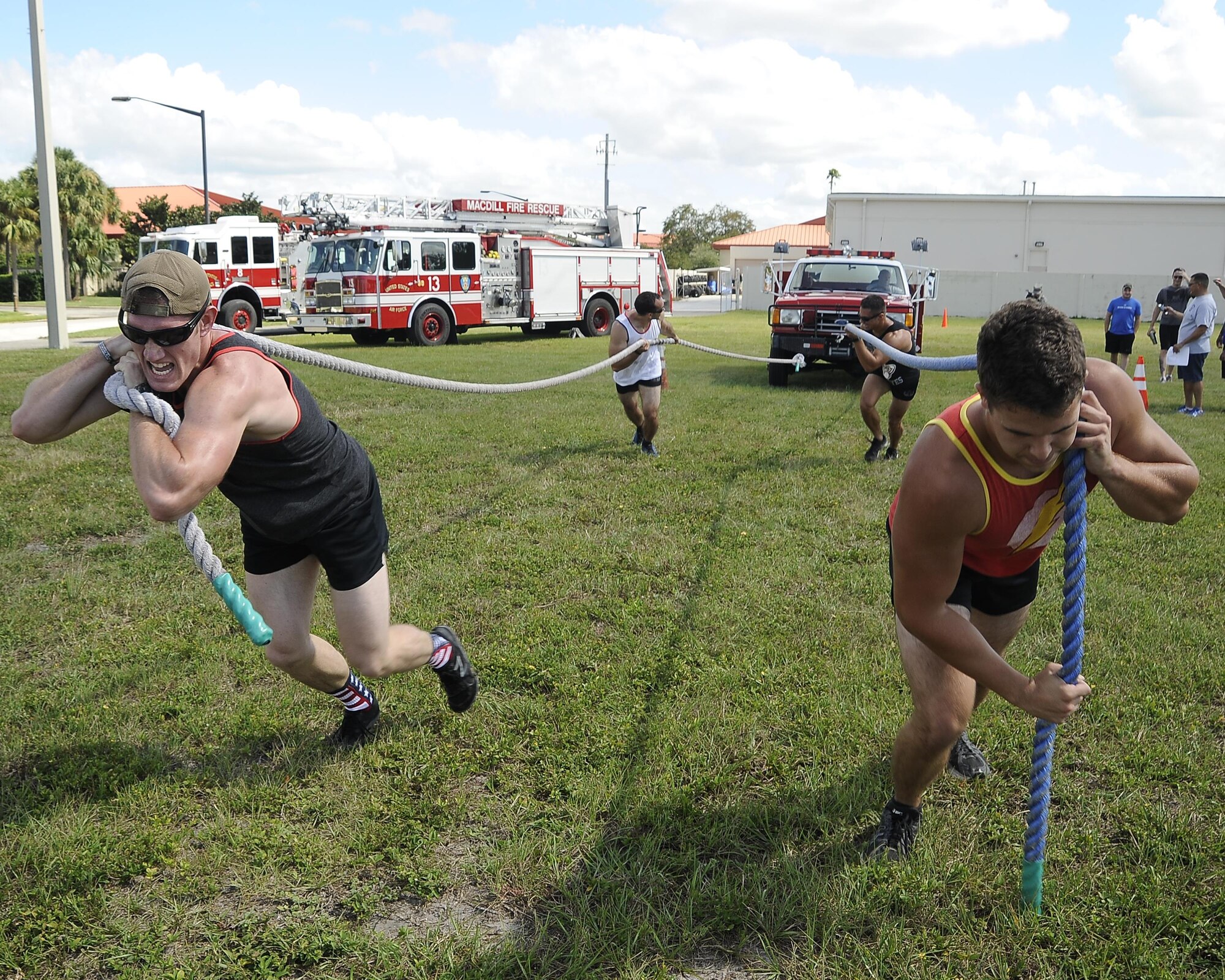 A participating team pulls a vehicle towards the finishing line during the MacDill’s Inaugural Firefighter’s Challenge at MacDill Air Force Base, Fla., Oct. 14, 2016. During the event, teams of four participated and performed both individual and group tasks in order to complete the challenge. (U.S. Air Force photo by Airman 1st Class Mariette Adams)