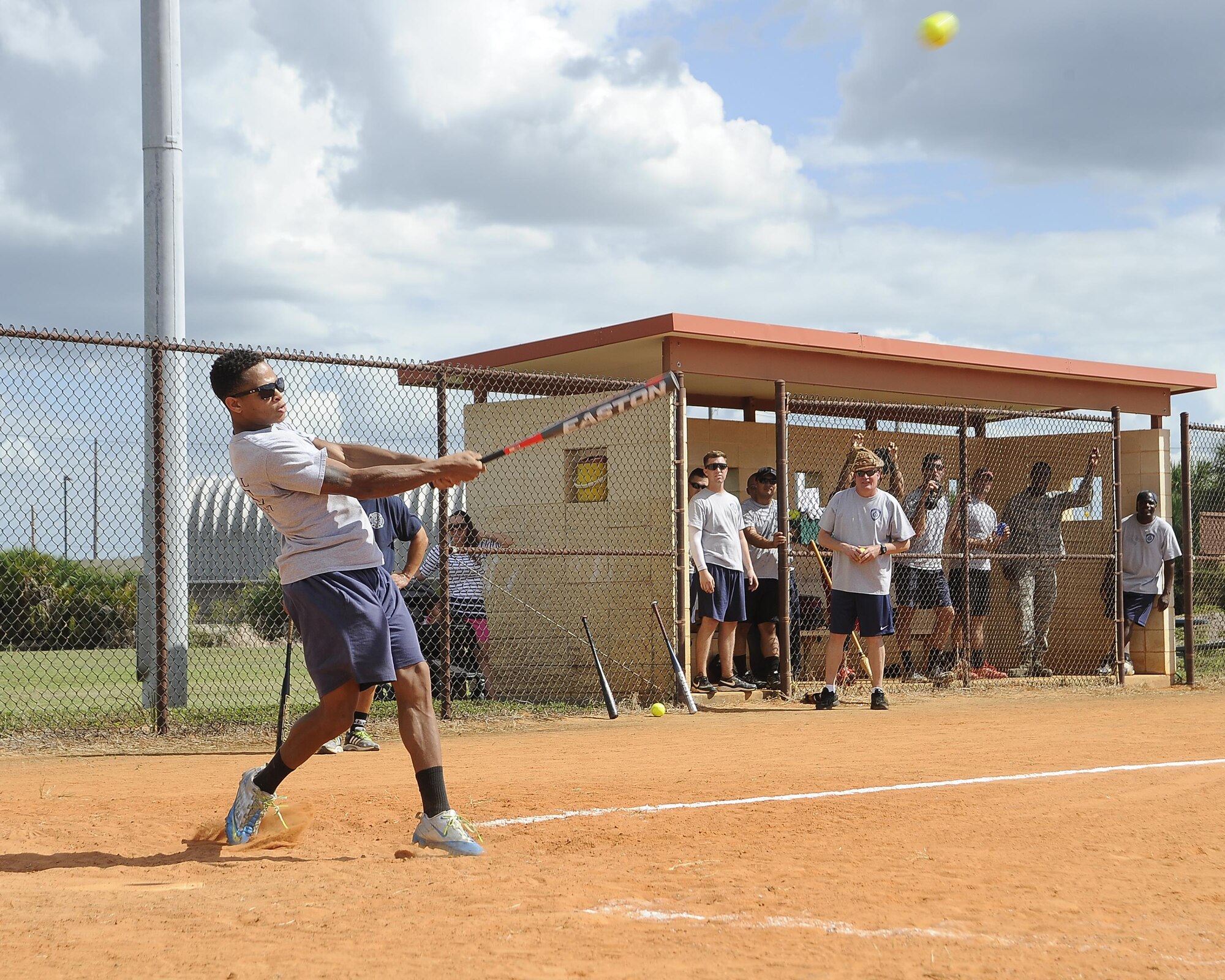 A firefighter assigned to the 6th Civil Engineer Squadron (CES) swings and hits the ball during Battle of the Badges at MacDill Air Force Base, Fla., Oct. 13, 2016. During the game, firefighters from the 6th CES and members from the 6th Security Forces Squadron battled it out as a part of MacDill’s Fire Prevention Week. (U.S. Air Force photo by Airman 1st Class Mariette Adams)