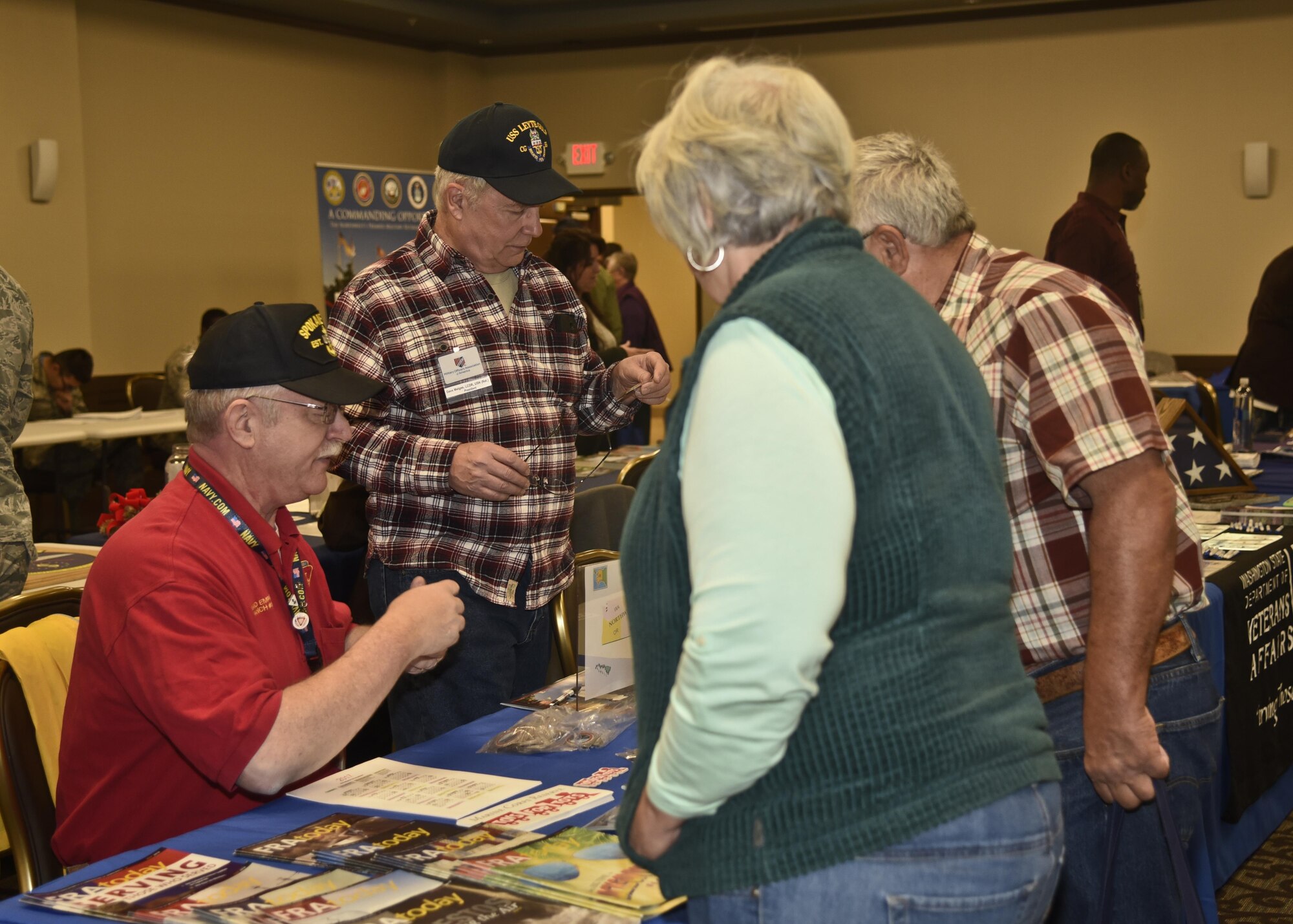 Retirees speak with a representative from Fleet Reserve Association during the Retiree Appreciation Day event Oct. 14, 2016, at the Red Morgan Center at Fairchild Air Force Base, Wash. The event included multiple booths from different agencies to explain their services, including: Veterans Affairs, base legal, American Legion and Tricare. During the event four informational presentations about Tricare, ID cards, legal assistance and casualty assistance were given. (U.S. Air Force photo/Airman 1st Class Taylor Shelton)