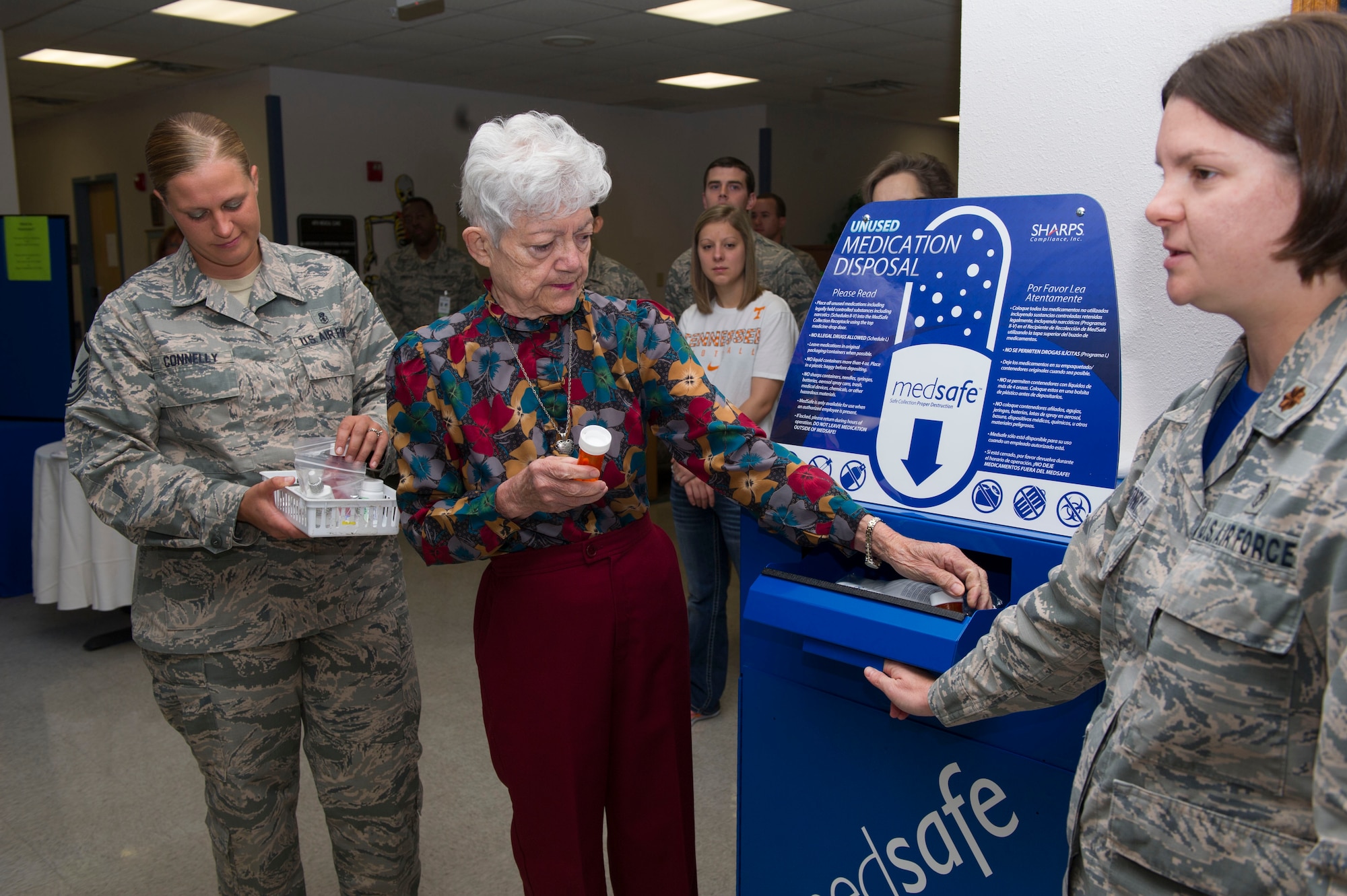 Matilda Smith, a retiree and pharmacy regular, deposits unused medications into the 49th Medical Group pharmacy’s new medication return container. Smith was the first person to donate medications as part of the medical group’s ceremony, Oct. 14, 2016. (U.S. Air Force photo by Tech. Sgt. Matthew Rosine.) 