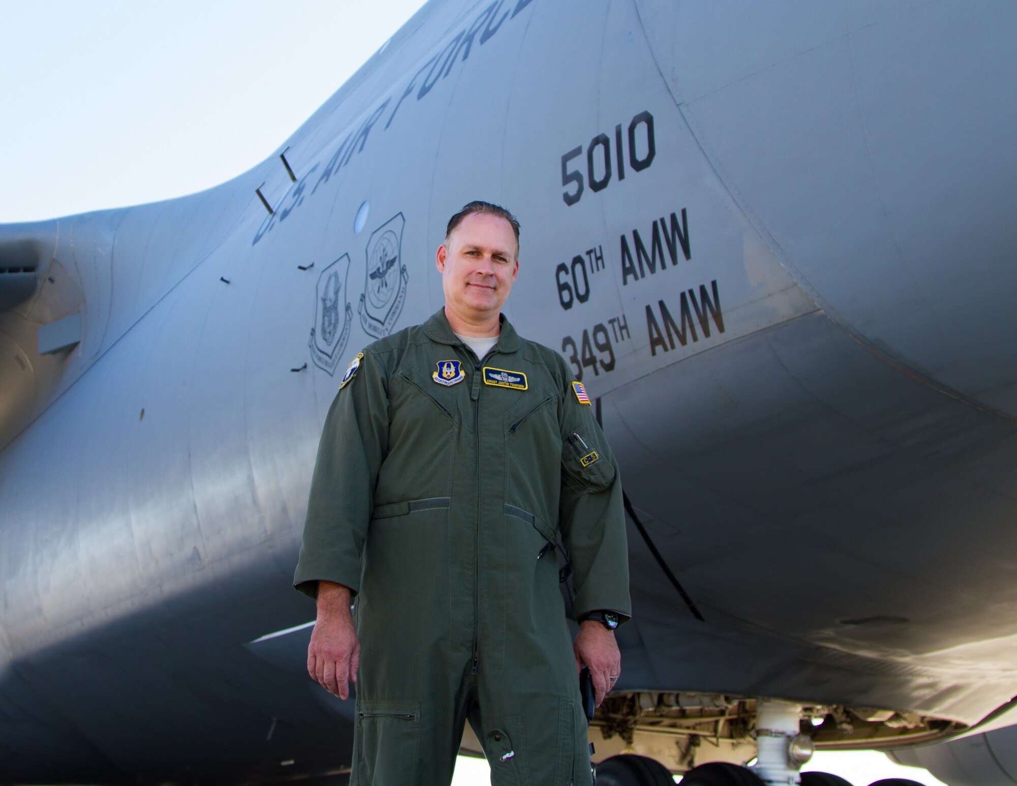 Chief Master Sgt. Justin Toomsen, 312th Airlift Squadron, poses for a photo outside a C-5M Super Galaxy at Travis Air Force Base, Calif. Toomsen challenges all Airmen to strive for excellence in all they do and maintain positive attitudes. (U.S. Air Force courtesy photo)