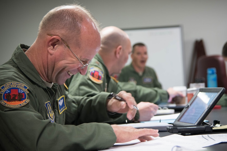 Senior Master Sgt. Michael Bolin, 36th Aeromedical Evacuation Squadron aeromedical evacuation technician reads safety guidelines during a mission briefing Oct. 14. The mission was the squadron's first out of Keesler Air Force Base, Miss. in coordination with the 53rd Weather Reconnaissance Squadron. (U.S. Air Force photo/Senior Airman Heather Heiney) 