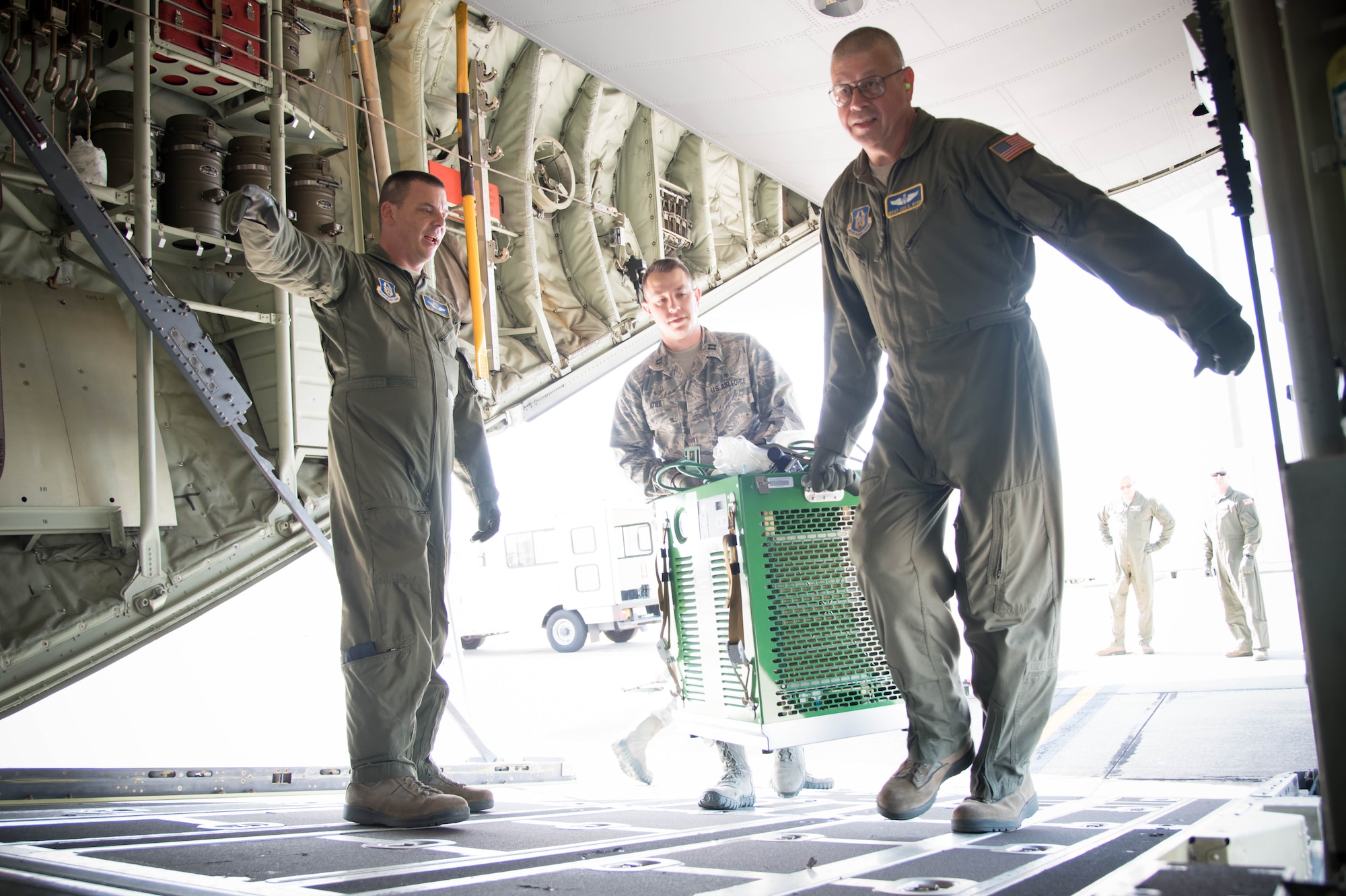 Members of the 36th Aeromedical Evacuation Squadron load equipment onto a 53rd Weather Reconnaissance Squadron WC-130J Super Hercules aircraft during a training mission Oct. 14 out of Keesler Air Force Base, Miss. This mission was the units' first time sharing an aircraft for a training mission. (U.S. Air Force photo/Senior Airman Heather Heiney) 