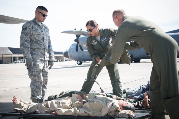 Members of the 36th Aeromedical Evacuation Squadron load medical training dummies onto a 53rd Weather Reconnaissance Squadron WC-130J Super Hercules aircraft during a training mission Oct. 14 out of Keesler Air Force Base, Miss. This mission was the units' first time sharing an aircraft for a training mission. (U.S. Air Force photo/Senior Airman Heather Heiney) 