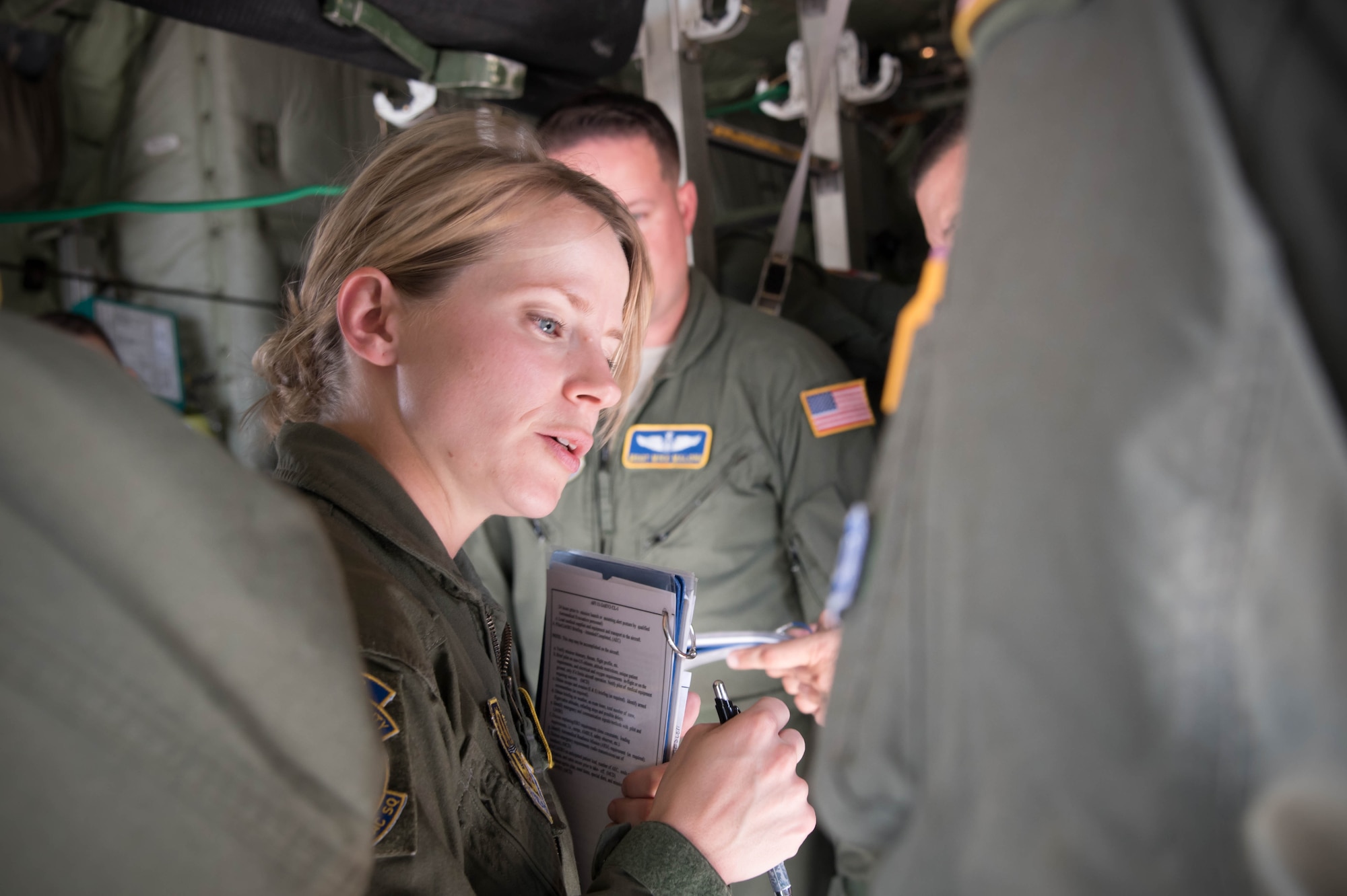 Maj. Jesse Walsh, 36th Aeromedical Evacuation Squadron flight nurse, discusses the squadron's needs with a pilot of the 53rd Weather Reconnaissance Squadron WC-130J Super Hercules aircraft during a training mission Oct. 14 out of Keesler Air Force Base, Miss. This mission was the units' first time sharing an aircraft for a training mission. (U.S. Air Force photo/Senior Airman Heather Heiney) 