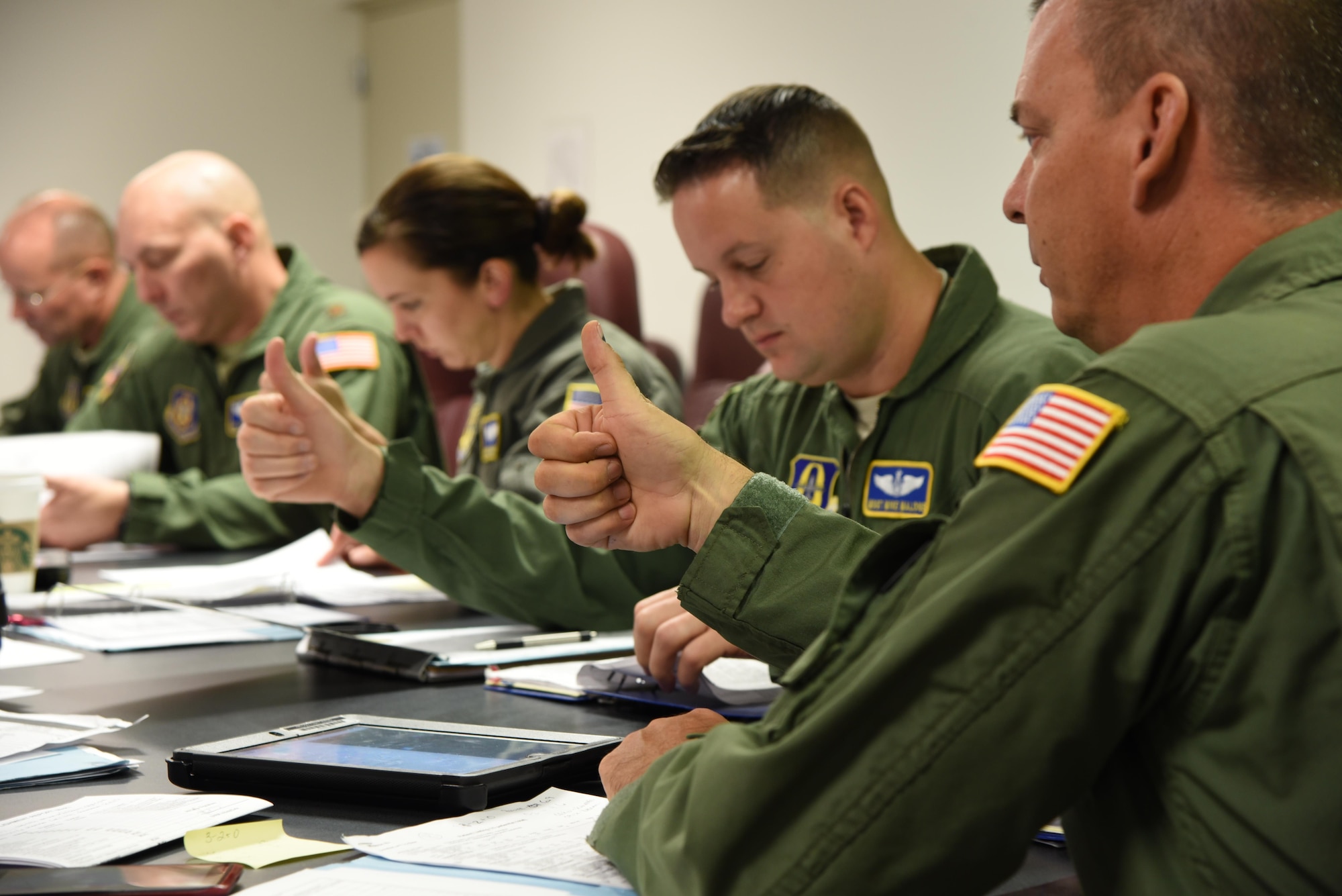 Members of the 36th Aeromedical Evacuation Squadron give the thumbs up to show their understanding of safety guidelines during a mission briefing Oct. 14. The mission was their first out of Keesler Air Force Base, Miss. in coordination with the 53rd Weather Reconnaissance Squadron. (U.S. Air Force photo/Maj. Marnee A.C. Losurdo)