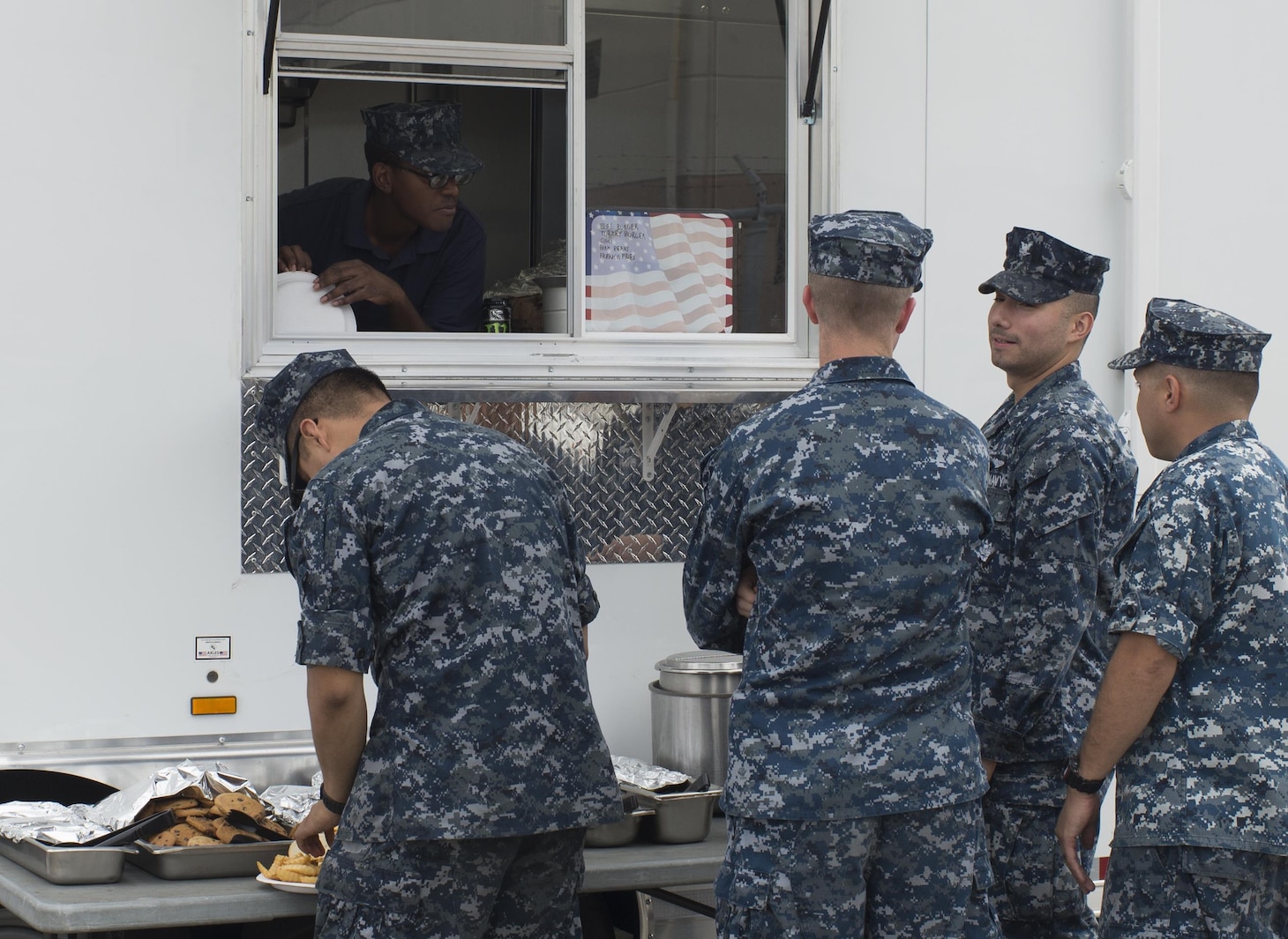 161014-N-KV911-044 PEARL HARBOR, Hawaii (Oct. 14, 2016) Sailor's stationed aboard the Los Angeles Class fast-attack submarine USS Columbus (SSN 762) order food at a mobile galley parked pierside. The mobile galley was recently purchased by Naval Submarine Support Command and is used to feed crews of boats undergoing galley maintenance.(U.S. Navy photo by Petty Officer 2nd Class Shaun Griffin/Released)