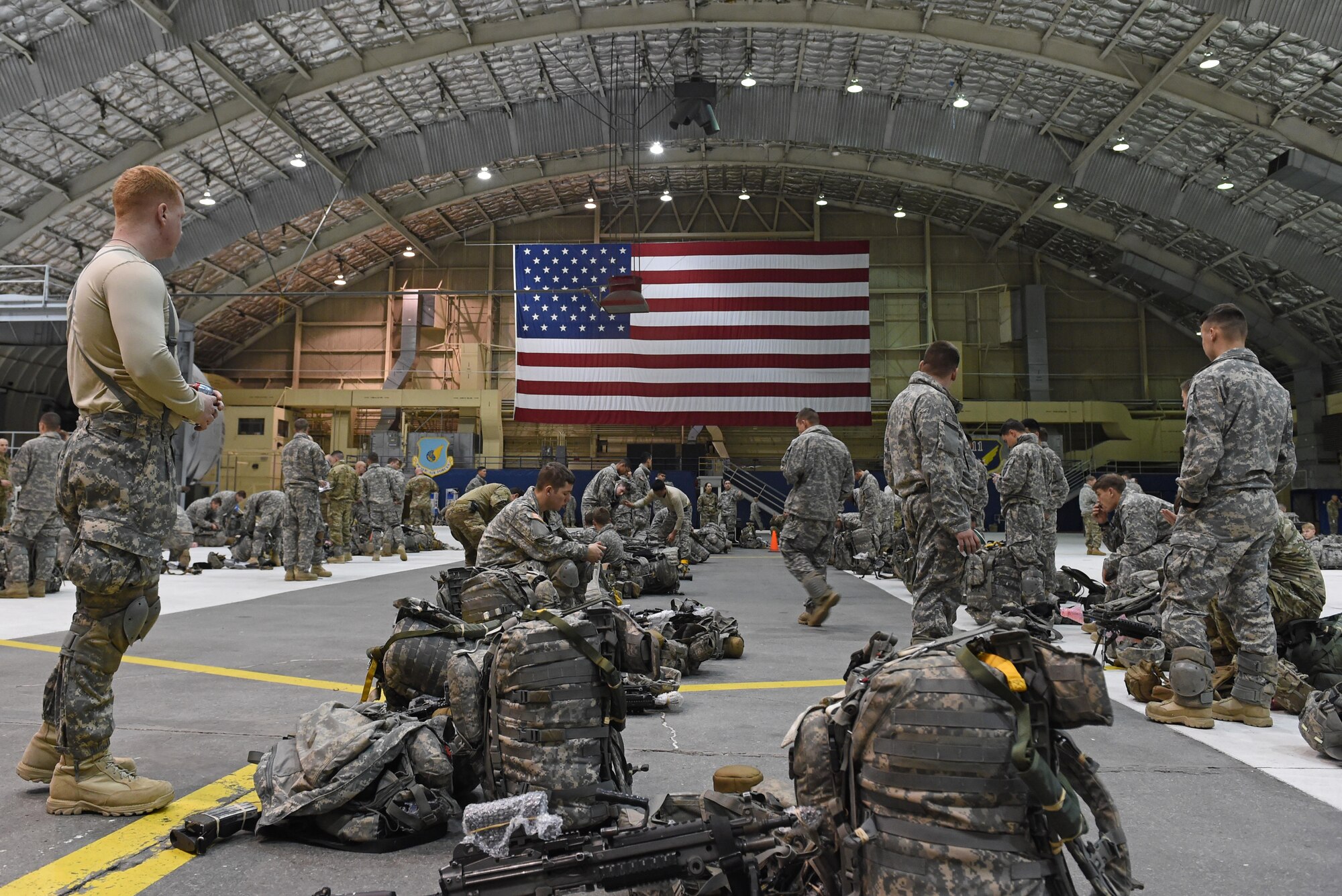 Paratroopers with the 4th Infantry Brigade Combat Team (Airborne), 25th Infantry Division, U.S. Army Alaska, gather at Hangar 1 before a jump at Joint Base Elmendorf-Richardson, Alaska, Oct. 12, 2016. The jump was part of Red Flag-Alaska 17-1, a training exercise for U.S. and international forces flown under simulated air combat conditions. 