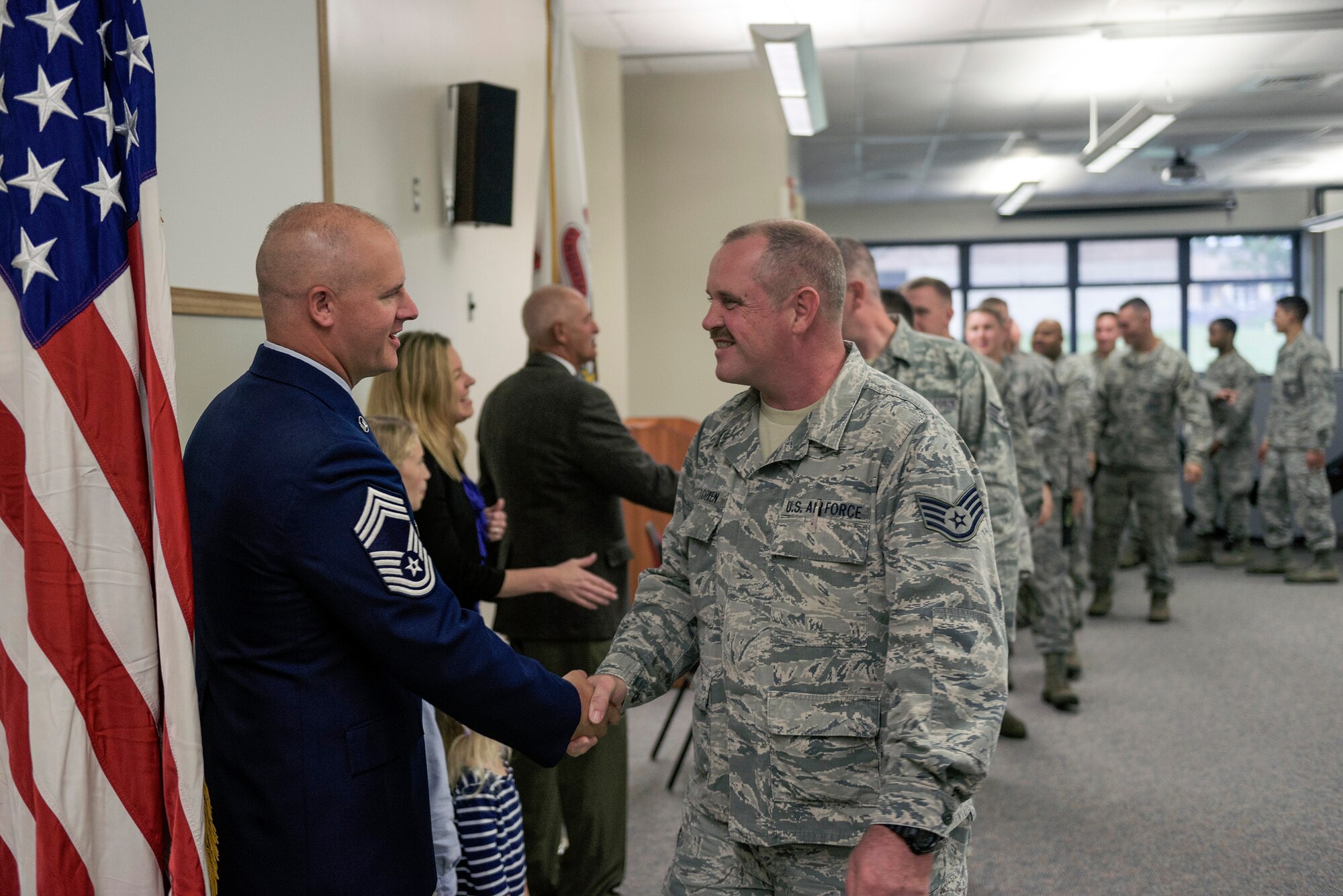 U.S. Air Force Chief Master Sgt. Clifford Otto III, left, the fire protection chief with the 182nd Civil Engineer Squadron, Illinois Air National Guard, receives congratulations during his promotion ceremony at the 182nd Airlift Wing in Peoria, Ill., Oct. 1, 2016. Otto has 18 years of active duty and ANG military service and has served with the 182nd since 2014. (U.S. Air National Guard photo by Tech. Sgt. Lealan Buehrer)