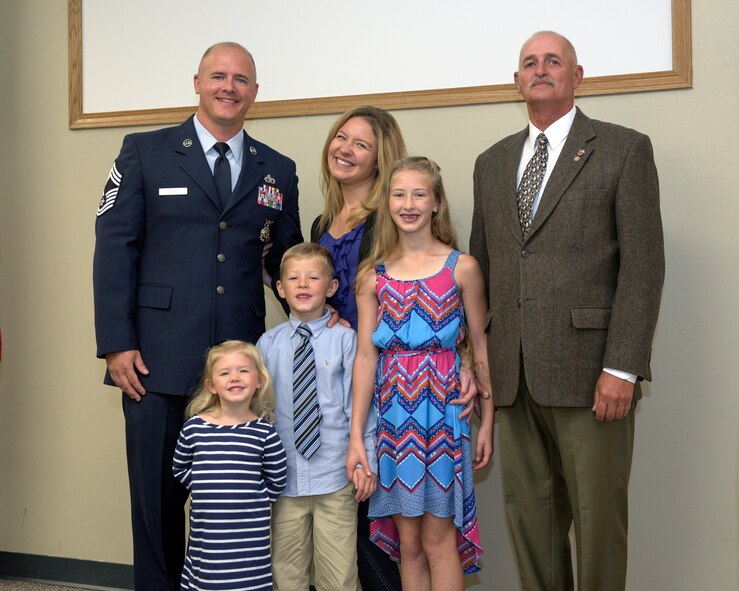U.S. Air Force Chief Master Sgt. Clifford Otto III, left, the fire protection chief with the 182nd Civil Engineer Squadron, Illinois Air National Guard, is pictured with his family during his promotion ceremony at the 182nd Airlift Wing in Peoria, Ill., Oct. 1, 2016. He has 18 years of active duty and ANG military service and has served with the 182nd since 2014. (U.S. Air National Guard photo by Tech. Sgt. Lealan Buehrer)