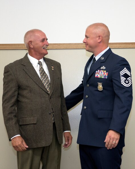 U.S. Air Force Chief Master Sgt. Clifford Otto III, right, the fire protection chief with the 182nd Civil Engineer Squadron, Illinois Air National Guard, is pictured with his father during Otto’s promotion ceremony at the 182nd Airlift Wing in Peoria, Ill., Oct. 1, 2016. He has 18 years of active duty and ANG military service and has served with the 182nd since 2014. (U.S. Air National Guard photo by Tech. Sgt. Lealan Buehrer)