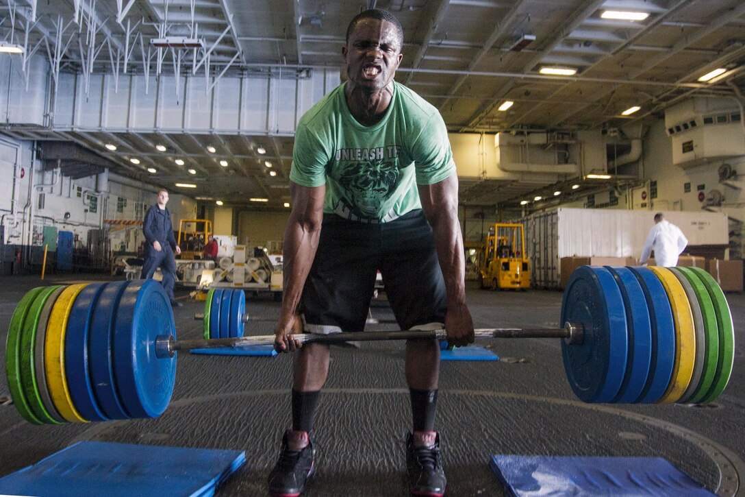 Navy Petty Officer 2nd Class Mark Forth deadlifts 505 pounds in the hangar bay of the USS George Washington in the Atlantic Ocean, Oct. 8, 2016. Navy photo by Petty Officer 3rd Class Brian Sloan