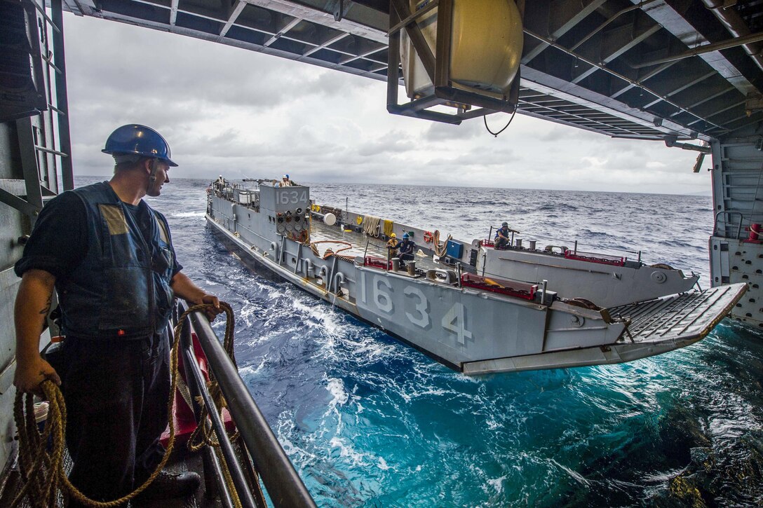 Navy Petty Officer 3rd Class David Coburn stands in the well deck of the USS Green Bay during Philippine Amphibious Landing Exercise 33 in the South China Sea, Oct. 8, 2016. Navy photo by Petty Officer 3rd Class Patrick Dionne