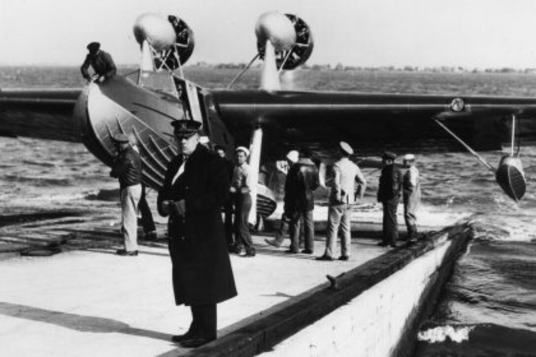 The commissioning of a flying lifeboat by Coast Guard Cmdr. Norman Hall on the Naval Operating Base-Norfolk amphibian flight deck. U.S. Coast Guard photo