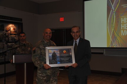 Brig. Gen. Alberto C. Rosende, commanding general for the 1st Mission Support Command, presents Brig. Gen. (Ret.) Fernando Fernandez with a token of appreciation during the Hispanic Heritage event held at Ramos Hall on Fort Buchanan, Puerto Rico, October 15th.