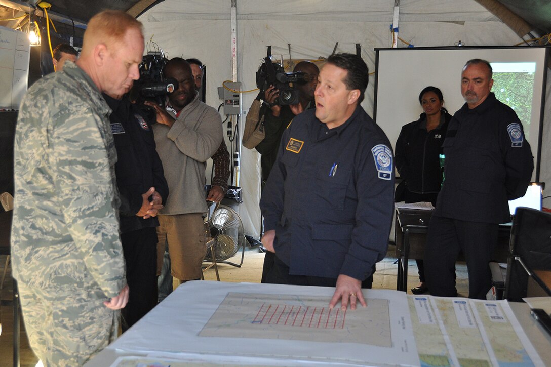 FEMA officials brief Col. Jim Kellogg, 94th Airlift Wing vice commander, on forward operations from their command post location on Dobbins Air Reserve Base, Georgia Oct. 12, 2016. Dobbins served as a staging location for the FEMA Urban Search and Rescue Blue Incident Support Team while they provided rapid federal response to local, federal, state and tribal agencies in support of Hurricane Matthew. (U.S. Air Force photo/James Branch)