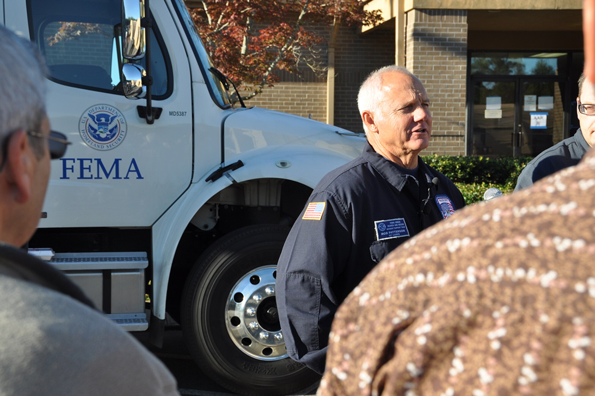Rob Patterson, FEMA Urban Search and Rescue Blue Incident Support Team leader, speaks to several media outlets at a FEMA command post location on Dobbins Air Reserve Base, Georgia Oct. 12, 2016. Dobbins served as a staging location for the team while they provided rapid federal response to local, federal, state and tribal agencies in support of Hurricane Matthew. (U.S. Air Force photo/James Branch)