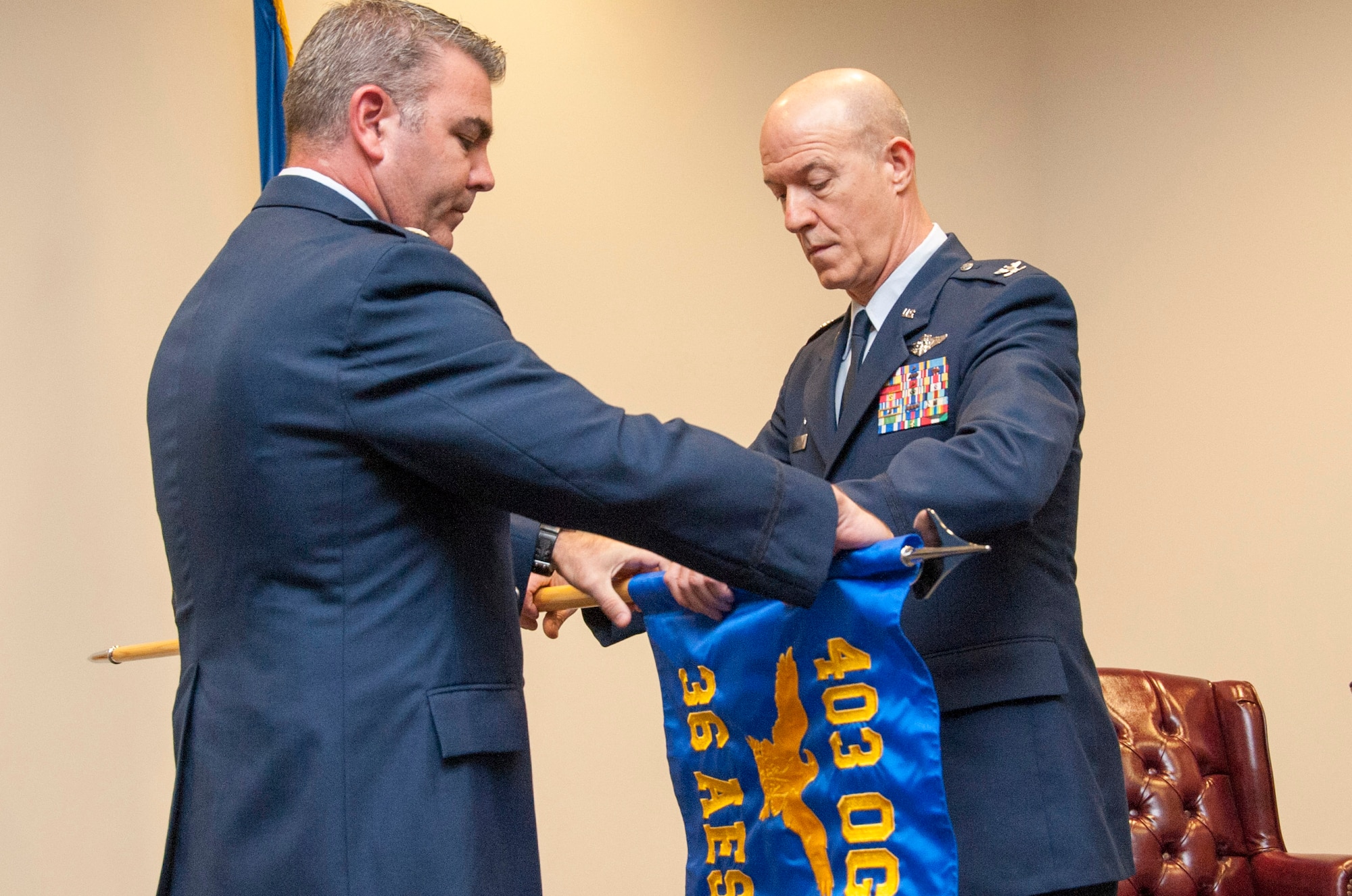 Col. Thomas Hansen (right), 36th Aeromedical Evacuation Squadron commander, and Lt. Col. Brian May, 403rd Operations Group commander, unfurl the 36th AES guidon during the squadron's redesignation ceremony Oct. 15, 2016, at Keesler Air Force Base, Mississippi. The unit relocated to Keesler AFB from Pope Field, N.C., and the squadron members are tasked with transporting wounded Soldiers, Sailors, Airmen and Marines by air to locations where they can receive critical medical care. (U.S. Air Force photo/Tech. Sgt. Ryan Labadens)