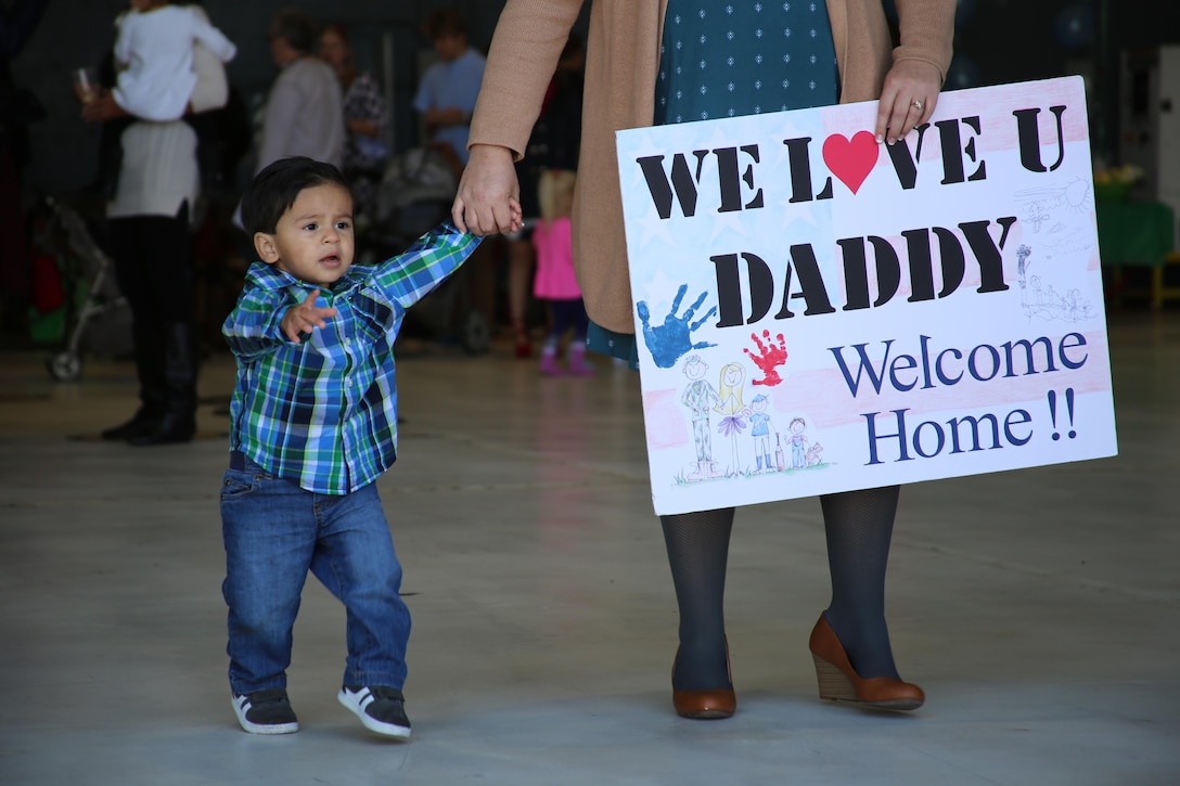 A child eagerly waits for his father during a deployment homecoming aboard Marine Corps Air Station Cherry Point, N.C., Oct. 10, 2016. More than 20 air crew members with Marine Tactical Electronic Warfare Squadron 4 returned after a six-month deployment with the United States Central Command aboard Incirlik Air Base in Turkey. According to Lt. Col. Paul K. Johnson III, commanding officer for VMAQ-4, the Marines conducted electronic warfare and disrupted ISIS communications in Iraq and Syria in support of Operation Inherent Resolve. This deployment was the last that VMAQ-4 will participate in because the squadron is scheduled to be deactivated in the summer of 2017. (U.S. Marine Corps photo by Lance Cpl. Mackenzie Gibson/Released)