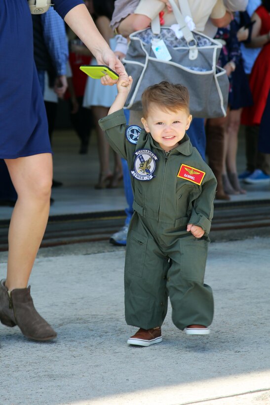 The son of Capt. Vincent Gonzalez waits for his father, Capt. Vincent Gonzalez, during a deployment homecoming aboard Marine Corps Air Station Cherry Point, N.C., Oct. 10, 2016. More than 20 air crew members with Marine Tactical Electronic Warfare Squadron 4 returned after a six-month deployment with the United States Central Command aboard Incirlik Air Base in Turkey. According to Lt. Col. Paul K. Johnson III, commanding officer for VMAQ-4, the Marines conducted electronic warfare and disrupted ISIS communications in Iraq and Syria in support of Operation Inherent Resolve. This deployment was the last that VMAQ-4 will participate in because the squadron is scheduled to be deactivated in the summer of 2017. Gonzalez is an electronic warfare officer with VMAQ-4. (U.S. Marine Corps photo by Lance Cpl. Mackenzie Gibson/Released)