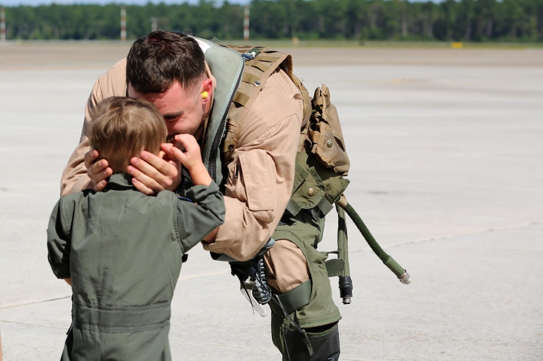 Capt. Vincent Gonzalez embraces his son during a deployment homecoming aboard Marine Corps Air Station Cherry Point, N.C., Oct. 10, 2016. More than 20 air crew members with Marine Tactical Electronic Warfare Squadron 4 returned after a six-month deployment with the United States Central Command aboard Incirlik Air Base in Turkey. According to Lt. Col. Paul K. Johnson III, commanding officer for Marine Tactical Electronic Warfare Squadron 4, the Marines conducted electronic warfare and disrupted ISIS communications in Iraq and Syria in support of Operation Inherent Resolve. This deployment was the last that VMAQ-4 will participate in because the squadron is scheduled to be deactivated in the summer of 2017. Gonzalez is an electronic warfare officer with VMAQ-4. (U.S. Marine Corps photo by Lance Cpl. Mackenzie Gibson/Released)