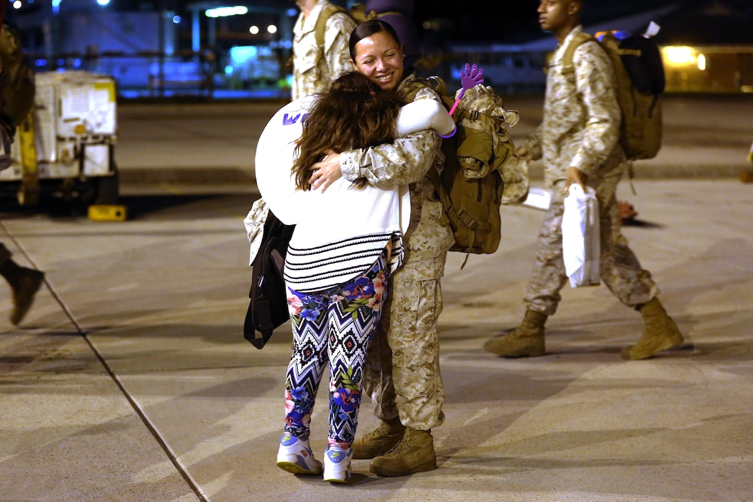 A Marine embraces her loved one during a deployment homecoming aboard Marine Corps Air Station Cherry Point, N.C., Oct. 15, 2016. More than 120 Marines with Marine Tactical Electronic Warfare Squadron 4 returned after a six-month deployment with the United States Central Command aboard Incirlik Air Base in Turkey. According to Lt. Col. Paul K. Johnson III, commanding officer for VMAQ-4, the Marines conducted electronic warfare and disrupted ISIS communications in Iraq and Syria in support of Operation Inherent Resolve. This deployment was the last that VMAQ-4 will participate in because the squadron is scheduled to be deactivated in the summer of 2017. (U.S. Marine Corps photo by Lance Cpl. Mackenzie Gibson/Released)