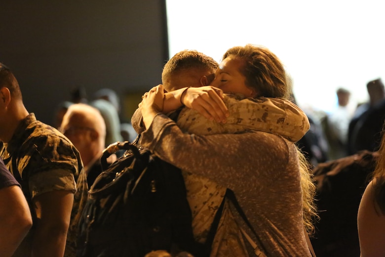 A Marine embraces his loved one during a deployment homecoming aboard Marine Corps Air Station Cherry Point, N.C., Oct. 15, 2016. More than 120 Marines with Marine Tactical Electronic Warfare Squadron 4 returned after a six-month deployment with the United States Central Command aboard Incirlik Air Base in Turkey. According to Lt. Col. Paul K. Johnson III, commanding officer for VMAQ-4, the Marines conducted electronic warfare and disrupted ISIS communications in Iraq and Syria in support of Operation Inherent Resolve. This deployment was the last that VMAQ-4 will participate in because the squadron is scheduled to be deactivated in the summer of 2017. (U.S. Marine Corps photo by Lance Cpl. Mackenzie Gibson/Released)
