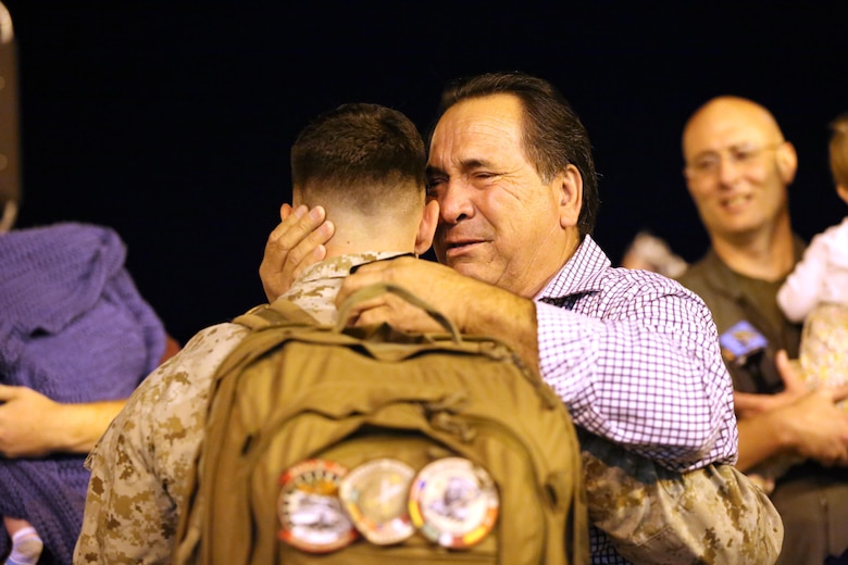 A Marine embraces his father during a deployment homecoming aboard Marine Corps Air Station Cherry Point, N.C., Oct. 15, 2016. More than 120 Marines with Marine Tactical Electronic Warfare Squadron 4 returned after a six-month deployment with the United States Central Command aboard Incirlik Air Base in Turkey. According to Lt. Col. Paul K. Johnson III, commanding officer for VMAQ-4, the Marines conducted electronic warfare and disrupted ISIS communications in Iraq and Syria in support of Operation Inherent Resolve. This deployment was the last that VMAQ-4 will participate in because the squadron is scheduled to be deactivated in the summer of 2017. (U.S. Marine Corps photo by Lance Cpl. Mackenzie Gibson/Released)