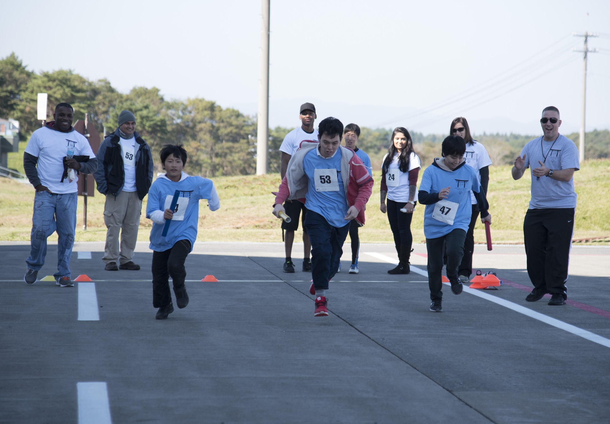 Keigo Imamiya, left, Izumi Yusuke, center, and Akemi Harata, right, Special Olympic athletes, participate in a 100-meter relay race during the 30th Annual Special Olympics at Misawa Air Base, Japan, Oct. 15, 2016. The event was held to get the local community involved and to continue to foster the relationship between the 35th Fighter Wing and Japanese nationals. (U.S. Air Force photo by Airman 1st Class Sadie Colbert)