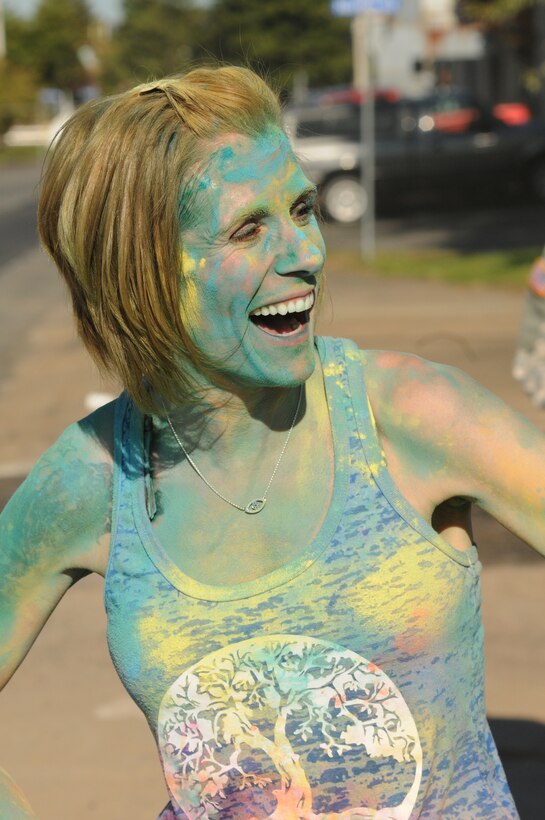 Tech. Sgt. Andria Allmond, 111th Attack Wing photojournalist, is covered in colored powder at the conclusion of the 111ATKW Military Fun Run held at Horsham Air Guard Station, Pa., Oct 15, 2016. The event was the first of its kind at Horsham AGS. (U.S. Air National Guard photo by Senior Airman Timi Jones)