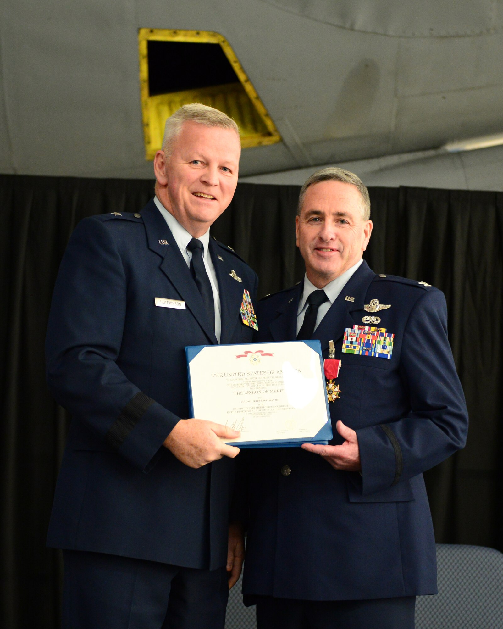 U.S. Air Force Big. Gen. Paul Hutchinson, commander, New Hampshire Air National Guard, presents Col. Peter Sullivan, 157th Air Refueling Wing vice wing commander, with a retirement certificate during Sullivan’s retirement ceremony, Pease Air National Guard Base, N.H., Oct. 15, 2016.  Sullivan retires with 34 years of service.  (U.S. Air National Guard photo by Senior Airman Ashlyn J. Correia)