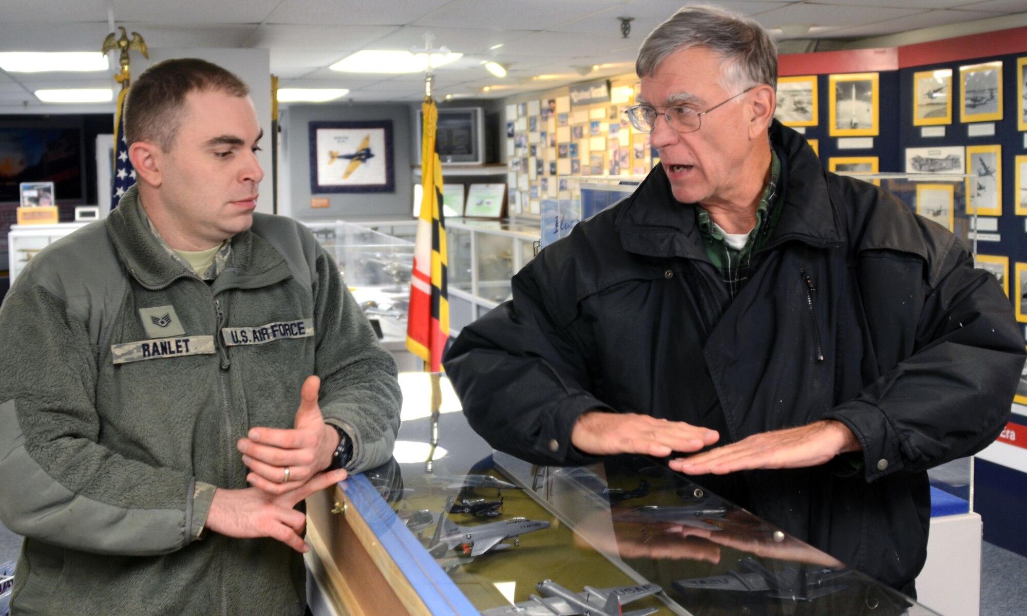 Staff Sgt. Dave Ranlet, 175th Logistic Readiness Squadron, listens to Ted Cooper, director of operations for the Glenn L. Martin Maryland Aviation Museum in Middle River, Md. Ranlet volunteers his off- duty time restoring planes displayed in the museum.  (U.S. Air National Guard photo by Tech. Sgt. David Speicher/RELEASED)