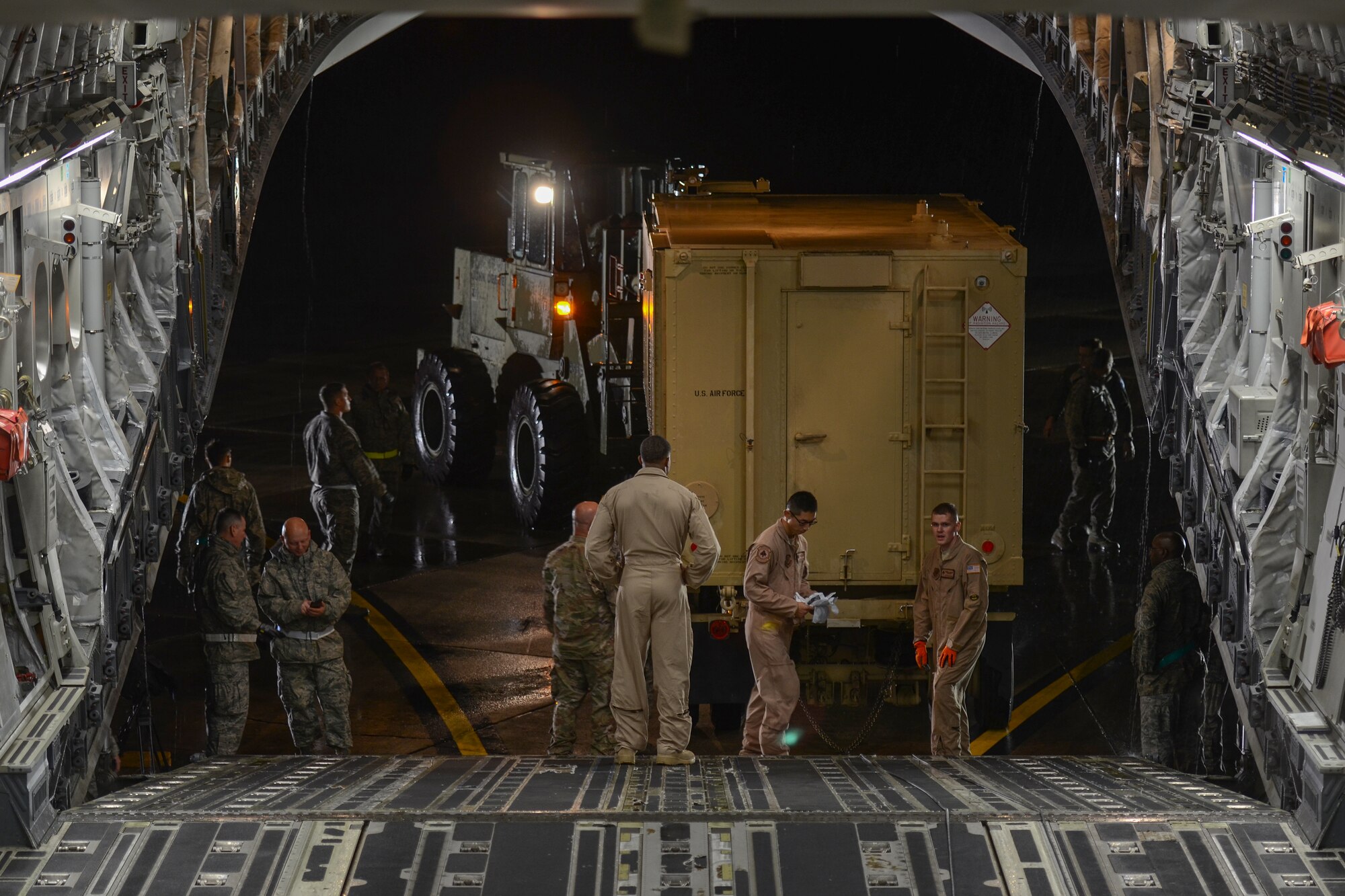 A U.S. C-17 Globemaster III, a large military transport aircraft, belonging to the 21st Airlift Squadron from Travis AFB, Calif., is being prepared for loading at McEntire Joint National Guard Base, S.C., Oct. 7, 2016. Equipment from the South Carolina Air National Guard's 245th Air Traffic Control Squadron was loaded onto the aircraft in preparation for a deployment in support of Operation INHERENT RESOLVE. (U.S. Air National Guard photo by Airman 1st Class Megan Floyd)