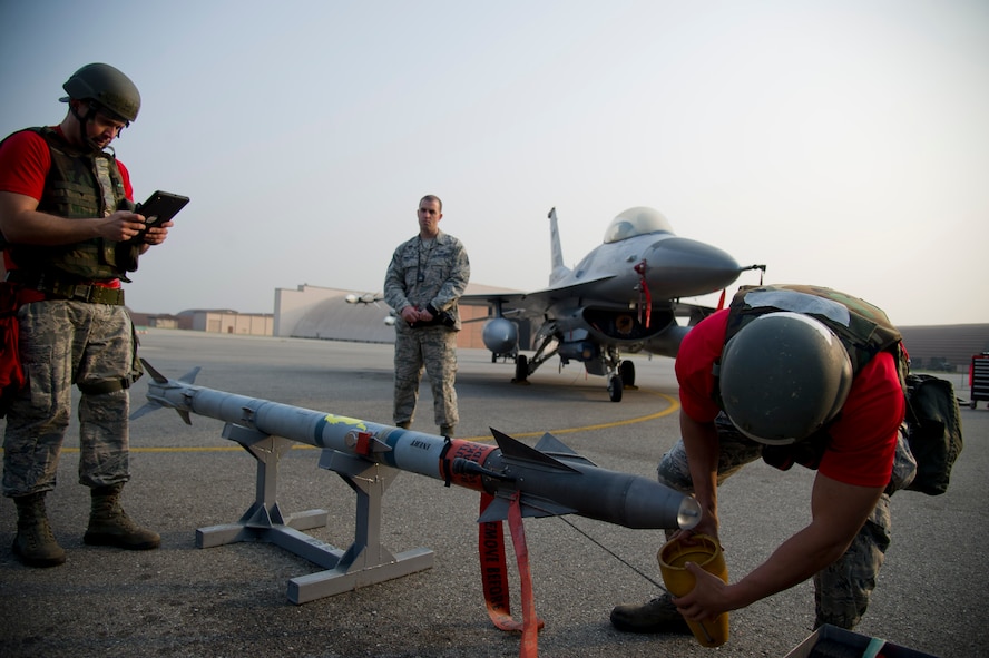 U.S. Air Force Staff Sgt. Jonathan Deacon, 36th Aircraft Maintenance Unit weapons load crew chief, and Senior Airman Zachary Ward, 36th AMU weapons load crew member, prepare an AIM-9 Sidewinder to be loaded onto an F-16 Fighting Falcon during the 51st Maintenance Group’s Weapons Load Crew of the Quarter competition at Osan Air Base, Republic of Korea, Oct. 14, 2016. The best weapons load crew from the 25th and 36th AMUs battle it out every quarter to see which unit can most quickly reload munitions on their respective aircraft. (U.S. Air Force photo by Staff Sgt. Jonathan Steffen)