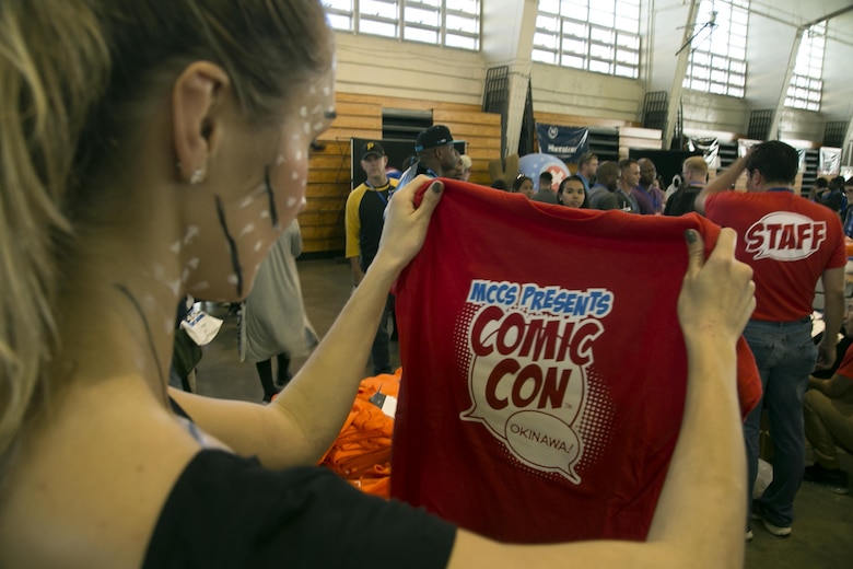 A Comic Con attendee views a t-shirt October 15 during Comic Con on Camp Foster, Okinawa, Japan. Comic Con is an annual gathering of comic book connoisseurs, video gamers, movie fans and artists across the island that participate in featured events such as: Pokémon tournaments, video game showdowns, cosplay and art contests, panel discussion and meet and greets with guest artists and voice actors. The free event was open for attendance to Status of Forces Agreement members and the local Okinawa community. (U.S. Marine Corps photo by Cpl. Brittany A. James / Released)