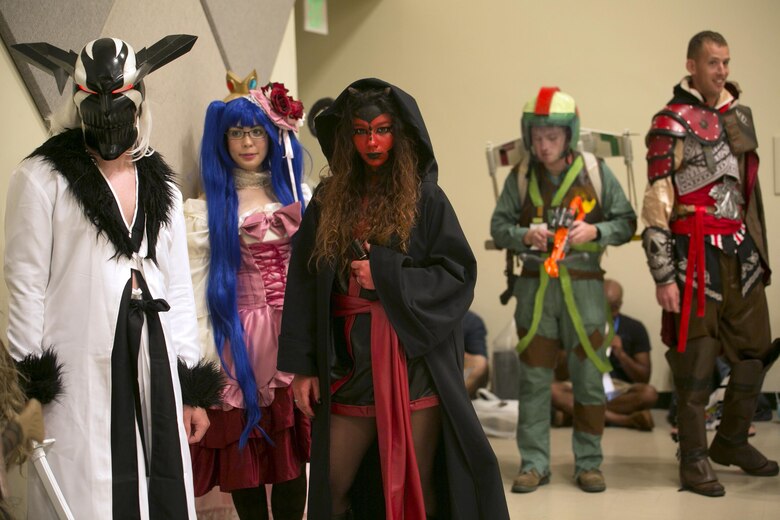 Cosplayers wait to be evaluated October 15 during the cosplay contest at Comic Con on Camp Foster, Okinawa, Japan. Comic Con is an annual gathering of comic book connoisseurs, video gamers, movie fans and artists across the island that participated in featured events such as: Pokémon tournaments, video game showdowns, cosplay and art contests, panel discussion and meet and greets with guest artists and voice actors. More than 25 attendees participated in the contest dressed as characters from video games, comic books and movies. The free event was open for attendance to Status of Forces Agreement members and the local Okinawa community. (U.S. Marine Corps photo by Cpl. Brittany A. James / Released)