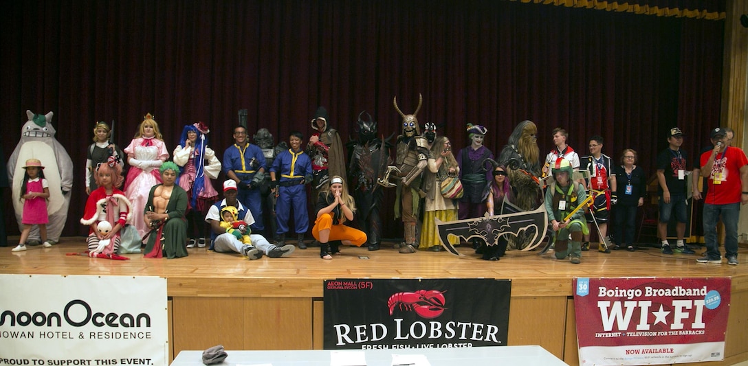 The cosplayers pose for a photo Oct. 15, awaiting the announcement of the winner of the cosplay contest at Comic Con on Camp Foster, Okinawa, Japan. More than 25 attendees participated in the cosplay contest dressed as characters from video games, comic books and movies. The contest featured participants dressed as characters from video games such as Kingdom Hearts, Fallout and Super Mario. There were also characters from movies and television shows such as Harry Potter and My Neighbor Totoro. Many of the participants’ costumes were made by hand. The free event was open for attendance to Status of Forces Agreement members and the local Okinawa community. (U.S. Marine Corps photo by Cpl. Brittany A. James / Released)