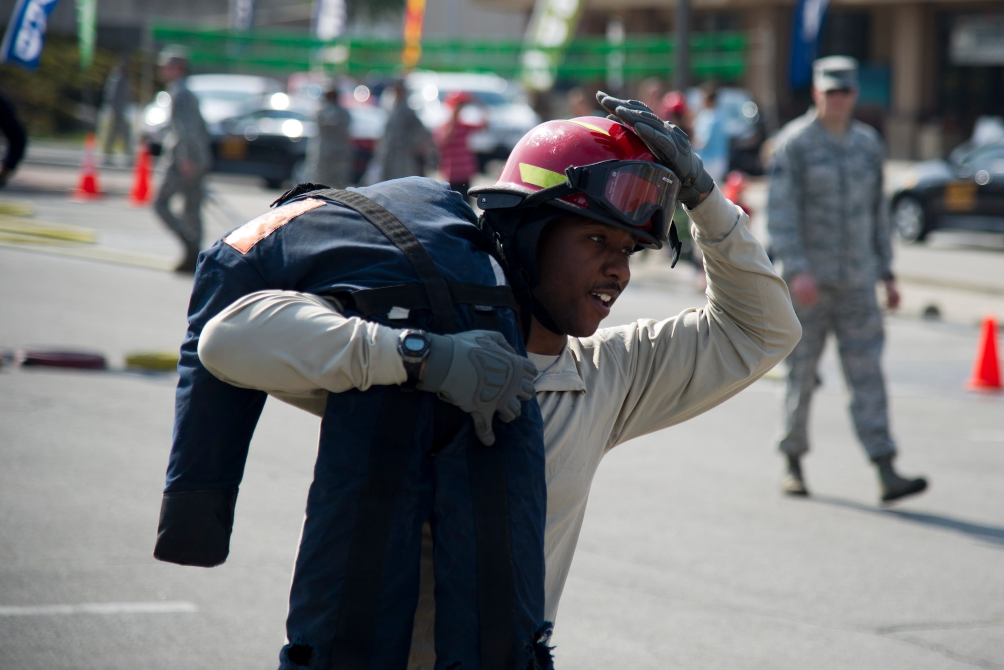 U.S. Air Force Staff Sgt. Mathew Berry, 51st Aerospace Medicine Squadron flight and operation medical technician, carries a dummy during Fire Muster 2016 on Osan Air Base, Republic of Korea, Oct. 13, 2016.  Osan’s firefighters organized the fire muster to bring awareness to Osan for Fire Prevention Week Oct. 9-15.  The fire muster put together teams of four in a relay race with teams competing in a variety of firefighting skills. (U.S. Air Force photo by Staff Sgt. Jonathan Steffen) 