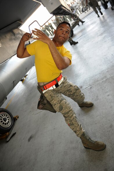 Staff Sgt. Dwight Hunter, 80th Aircraft Maintenance Unit load crew member, tightens a bolt during the Weapons Load Crew of the Quarter competition at Kunsan Air Base, Republic of Korea, Oct. 14, 2016. The event consisted of members from the 38th Logistics Squadron, 80th AMU and 35th AMU competing in a timed munitions load. This was the first year the ROK Air Force and U.S. Air Force participated in the event together. (U.S. Air Force photo by Senior Airman Michael Hunsaker/Released)