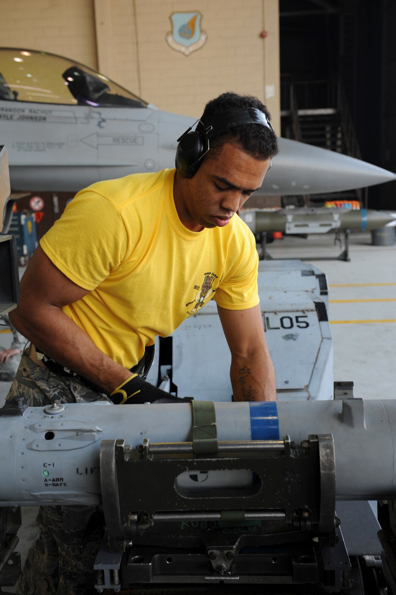 Staff Sgt. Dwight Hunter, 80th Aircraft Maintenance Unit load crew member, secures an inert munition during the Weapons Load Crew of the Quarter competition at Kunsan Air Base, Republic of Korea, Oct. 14, 2016. The event consisted of members from the 38th Logistics Squadron, 80th AMU and 35th AMU competing in a timed munitions load. This was the first year the ROK Air Force and U.S. Air Force participated in the event together. (U.S. Air Force photo by Senior Airman Michael Hunsaker/Released)