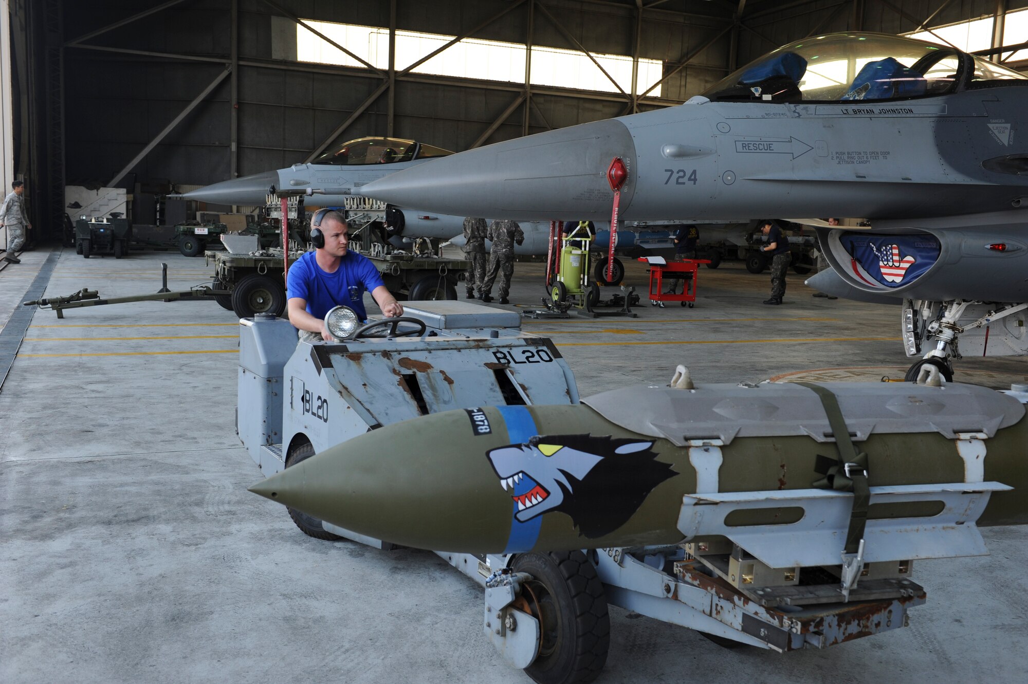 Senior Airman Erik Lisle, 35th Aircraft Maintenance Unit load crew member, transports an inert munition during the Weapons Load Crew of the Quarter competition at Kunsan Air Base, Republic of Korea, Oct. 14, 2016. The event consisted of members from the 38th Logistics Squadron, 80th AMU and 35th AMU competing in a timed munitions load. This was the first year the ROK Air Force and U.S. Air Force participated in the event together. (U.S. Air Force photo by Senior Airman Michael Hunsaker/Released)
