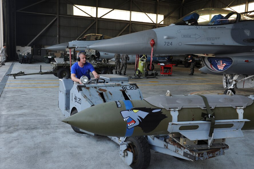 Senior Airman Erik Lisle, 35th Aircraft Maintenance Unit load crew member, transports an inert munition during the Weapons Load Crew of the Quarter competition at Kunsan Air Base, Republic of Korea, Oct. 14, 2016. The event consisted of members from the 38th Logistics Squadron, 80th AMU and 35th AMU competing in a timed munitions load. This was the first year the ROK Air Force and U.S. Air Force participated in the event together. (U.S. Air Force photo by Senior Airman Michael Hunsaker/Released)