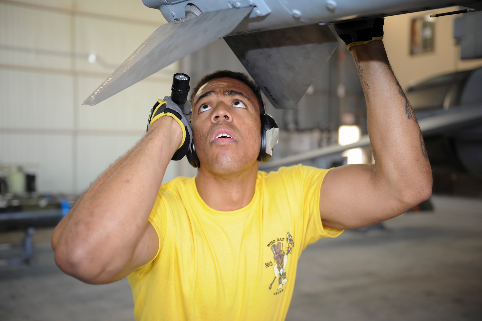 Staff Sgt. Dwight Hunter, 80th Aircraft Maintenance Unit load crew member, inspects an inert munition during the Weapons Load Crew of the Quarter competition at Kunsan Air Base, Republic of Korea, Oct. 14, 2016. The event consisted of members from the 38th Logistics Squadron, 80th AMU and 35th AMU competing in a timed munitions load. This was the first year the ROK Air Force and U.S. Air Force participated in the event together. (U.S. Air Force photo by Senior Airman Michael Hunsaker/Released)