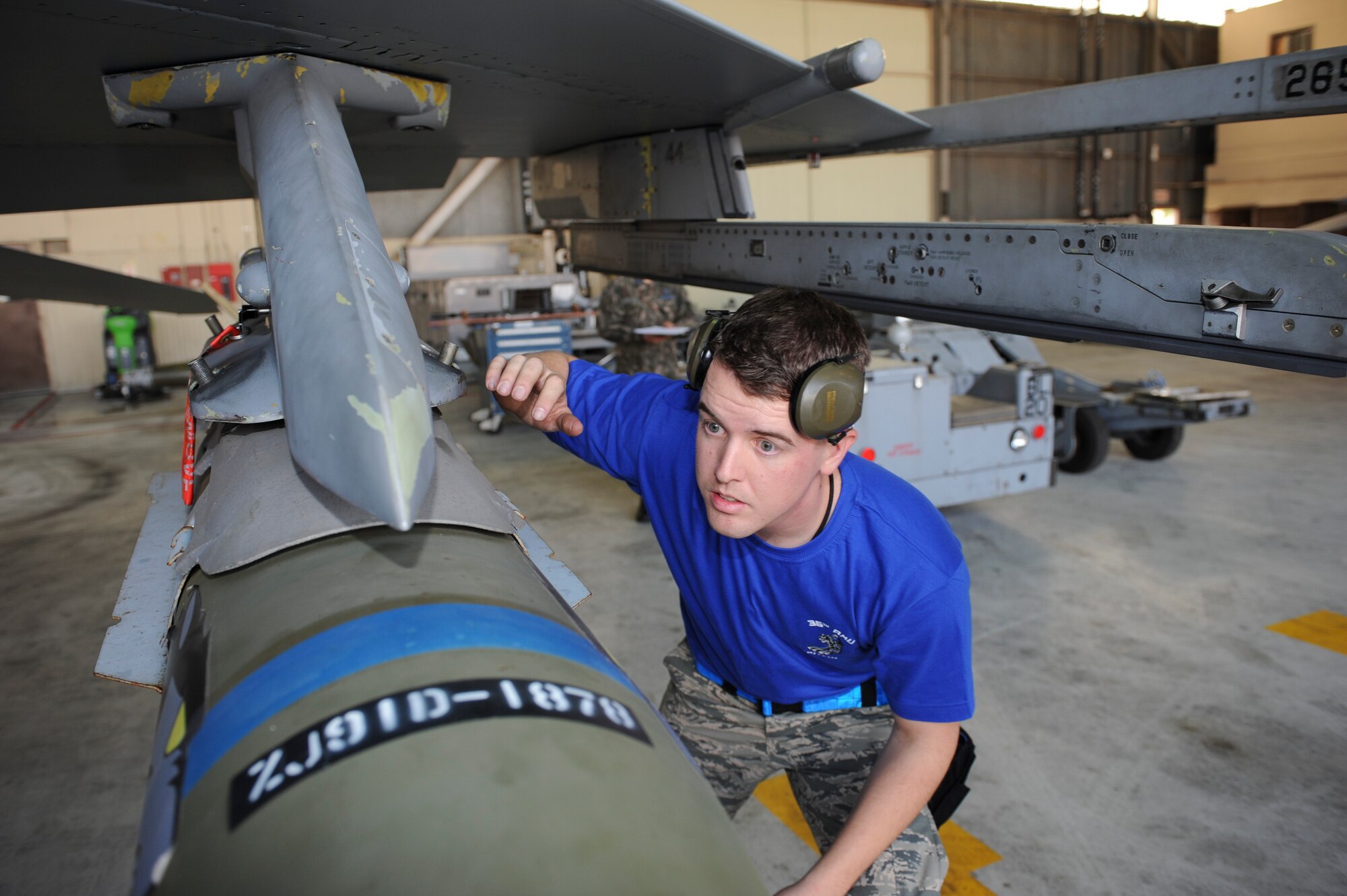 Staff Sgt. Jeffery Hunt, 35th Aircraft Maintenance Unit load crew member, inspects an inert munition during the Weapons Load Crew of the Quarter competition at Kunsan Air Base, Republic of Korea, Oct. 14, 2016. The event consisted of members from the 38th Logistics Squadron, 80th AMU and 35th AMU competing in a timed munitions load. This was the first year the ROK Air Force and U.S. Air Force participated in the event together. (U.S. Air Force photo by Senior Airman Michael Hunsaker/Released)