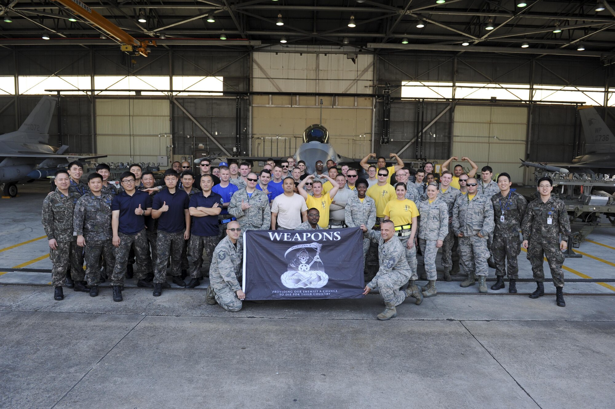 Members of 38th Logistics Squadron, 80th Aircraft Munitions Squadron and 35th AMU conclude the Weapons Load Crew of the Quarter competition at Kunsan Air Base, Republic of Korea, Oct. 14, 2016. The event consisted of members from the 38th Logistics Squadron, 80th AMU and 35th AMU competing in a timed munitions load. This was the first year the ROK Air Force and U.S. Air Force participated in the event together. (U.S. Air Force photo by Senior Airman Michael Hunsaker/Released)