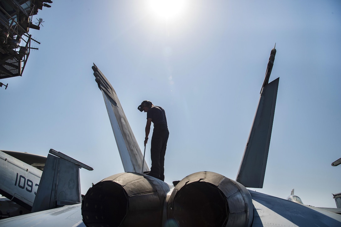 Navy Seaman Jeremiah Milligan washes an F/A-18E Super Hornet aircraft assigned to Strike Fighter Squadron 105 on the flight deck of the aircraft carrier USS Dwight D. Eisenhower in the Persian Gulf, Oct. 14, 2016. Milligan is an aviation structural mechanic. Navy photo by Petty Officer 3rd Class Robert J. Baldock